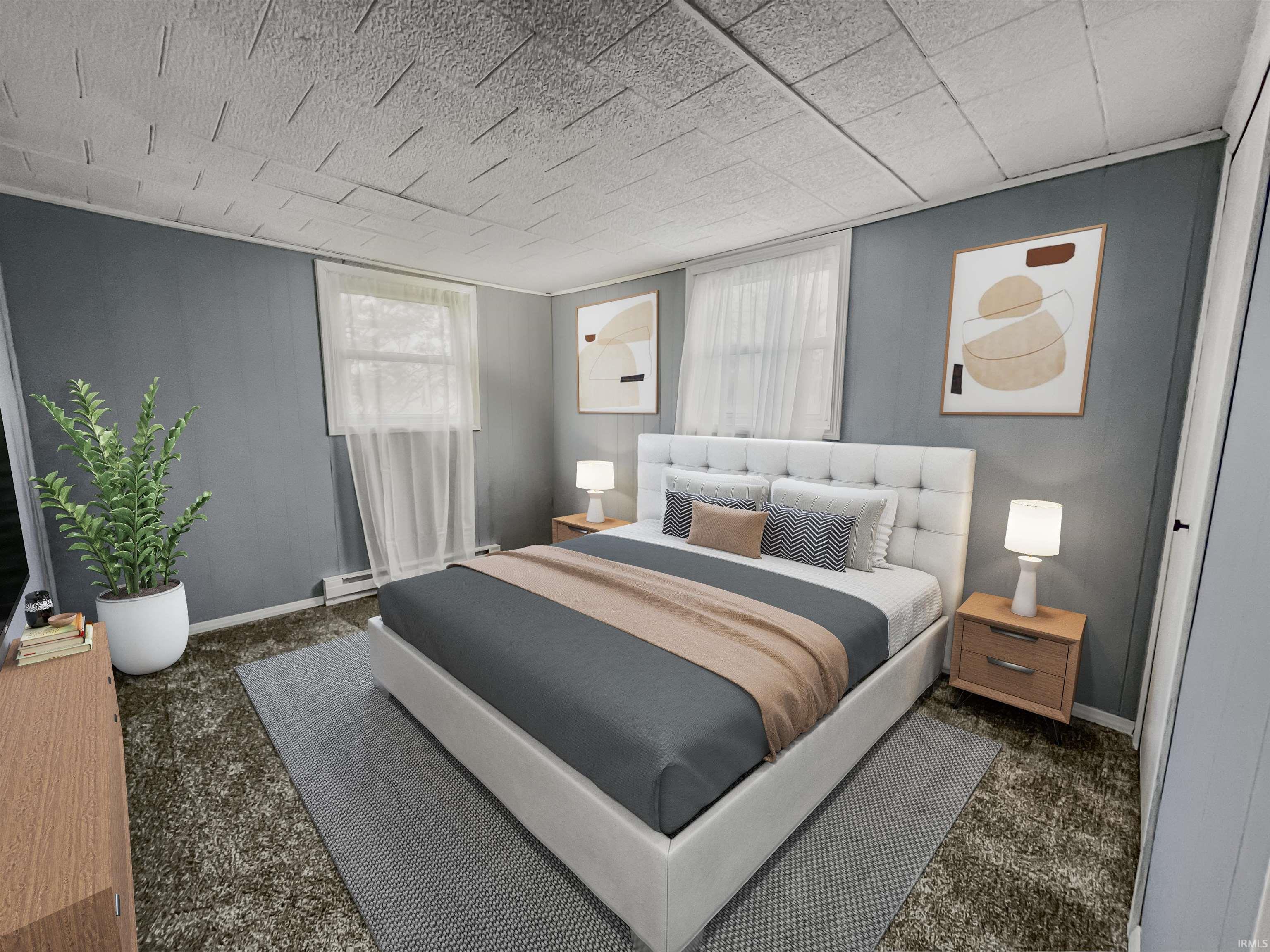 Inviting bedroom featuring plush carpet flooring and cool gray walls