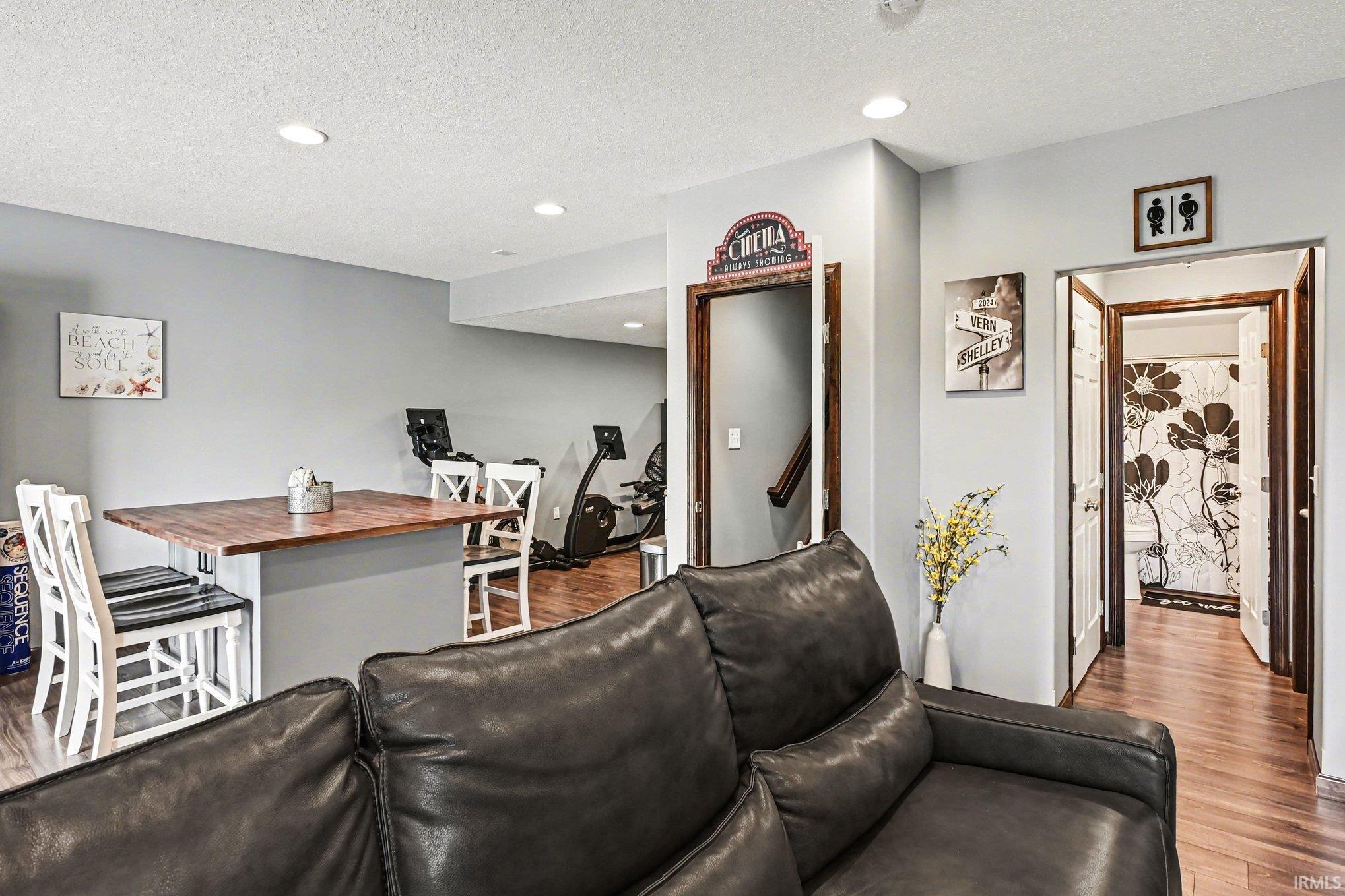 Open-concept living area featuring recessed lighting and wood-finish flooring