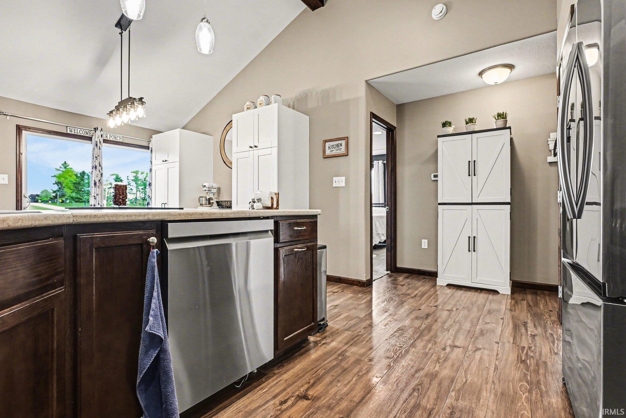 Kitchen featuring wood-finish flooring and a vaulted ceiling