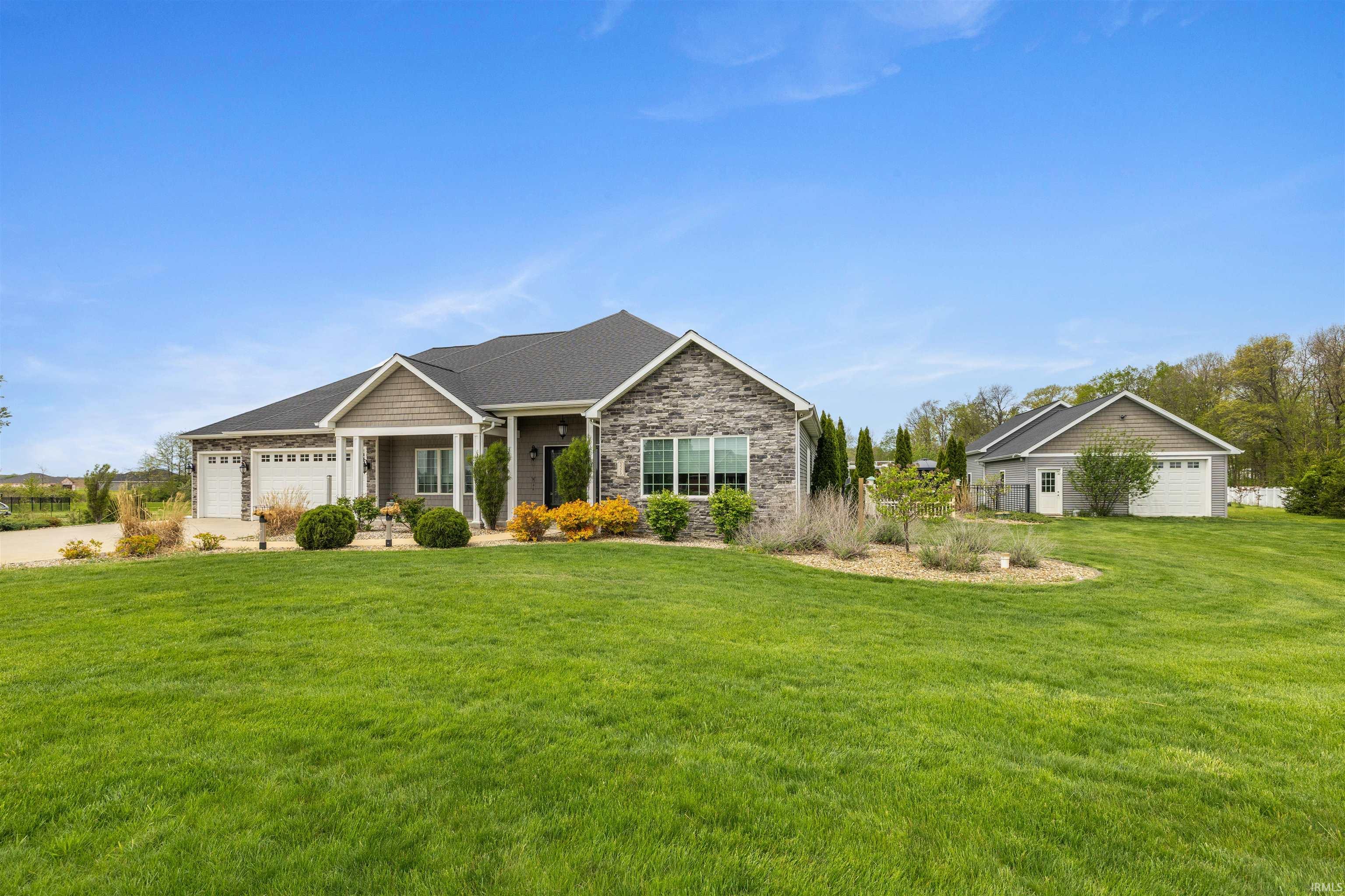 Stone and siding exterior with a dark shingle roof