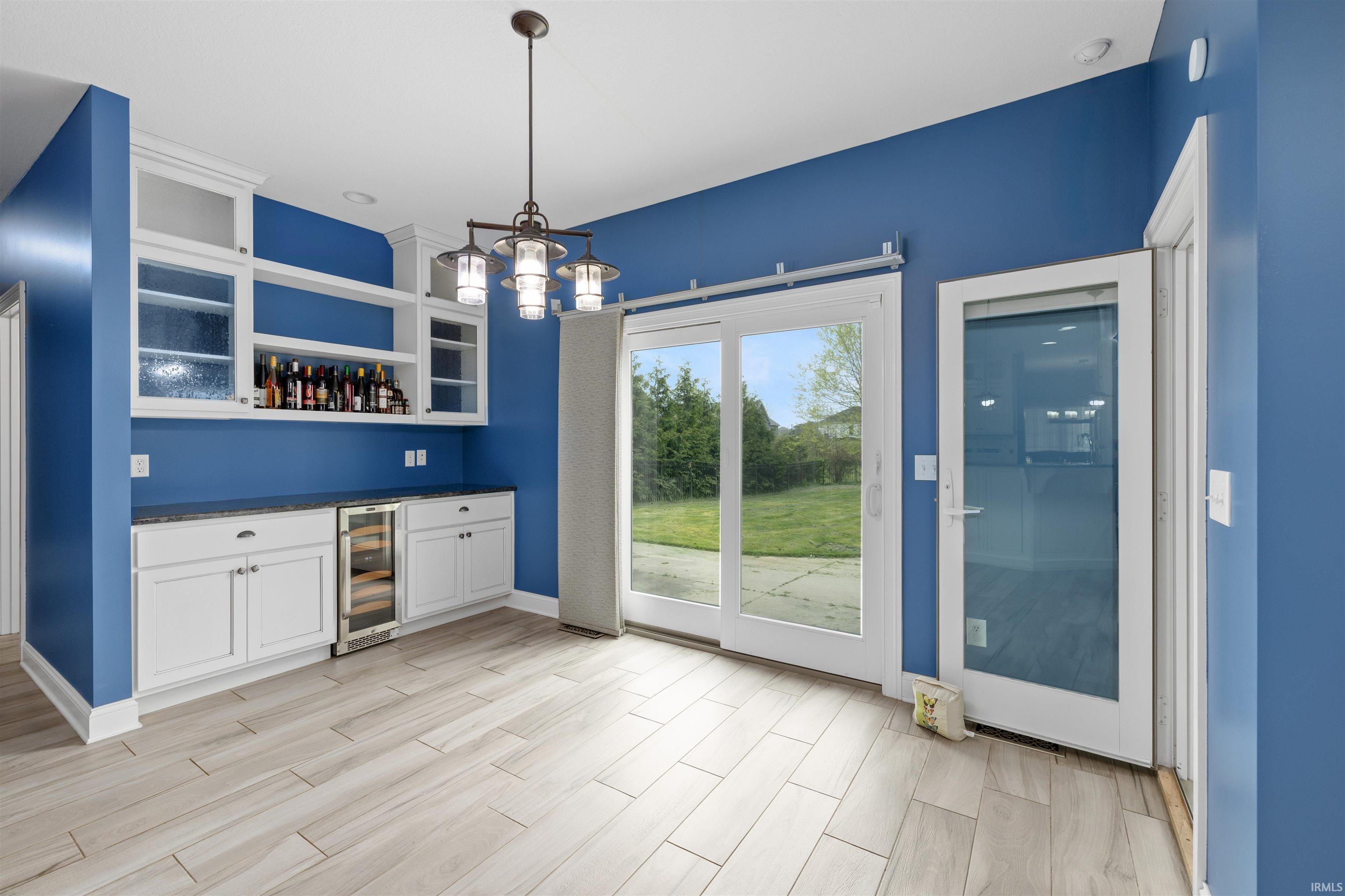 Built-in cabinetry with display shelving and a beverage refrigerator