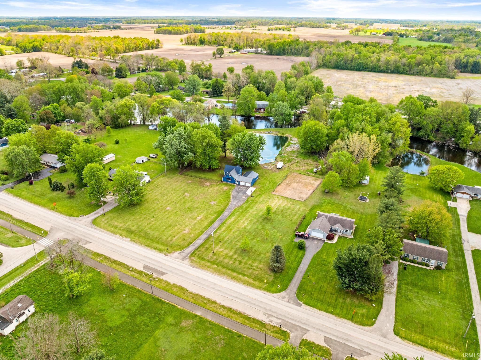 Expansive property featuring verdant green lawns and mature trees