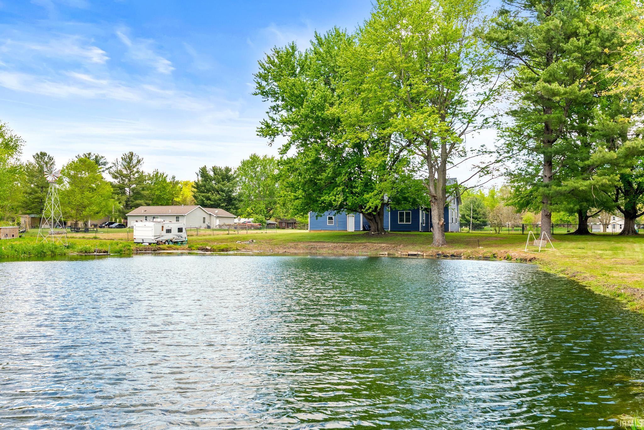 Serene pond feature with verdant surrounding foliage