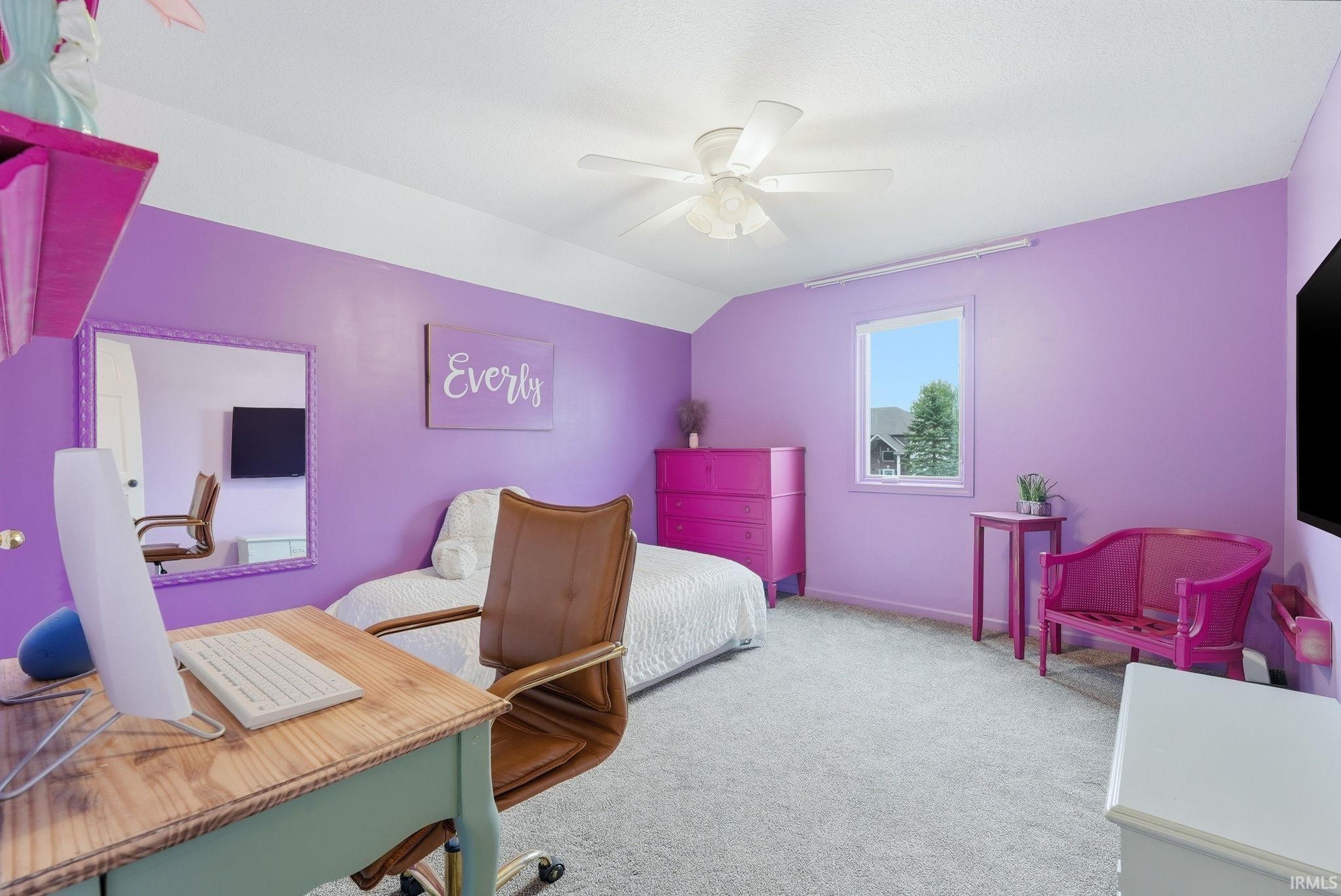 Spacious room featuring light lavender walls with a white ceiling, a single window, and a ceiling fan