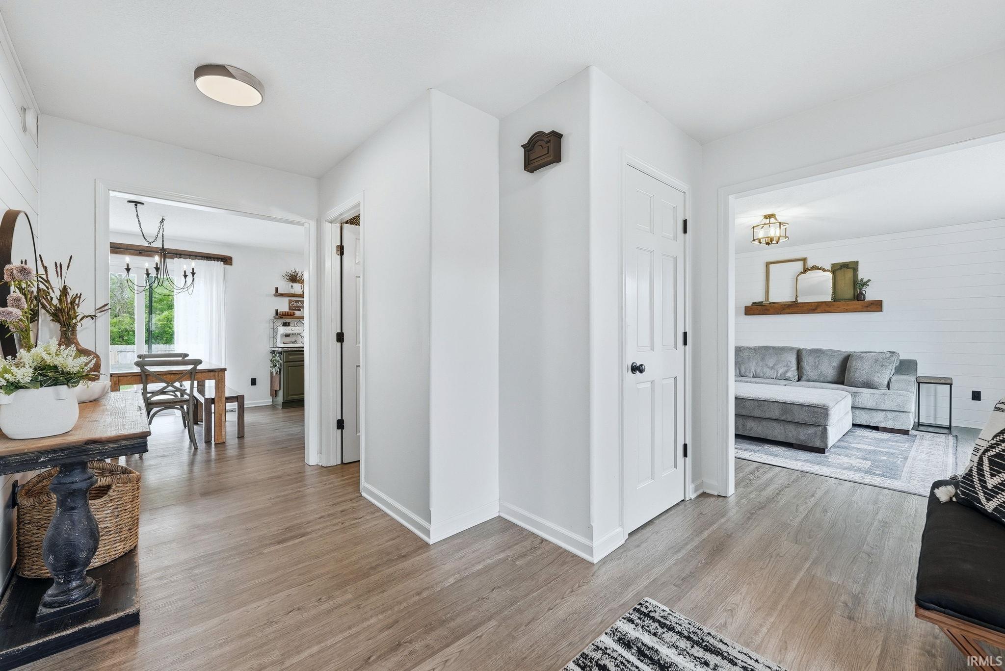 Bright interior featuring wood-finish flooring, white walls, and recessed lighting