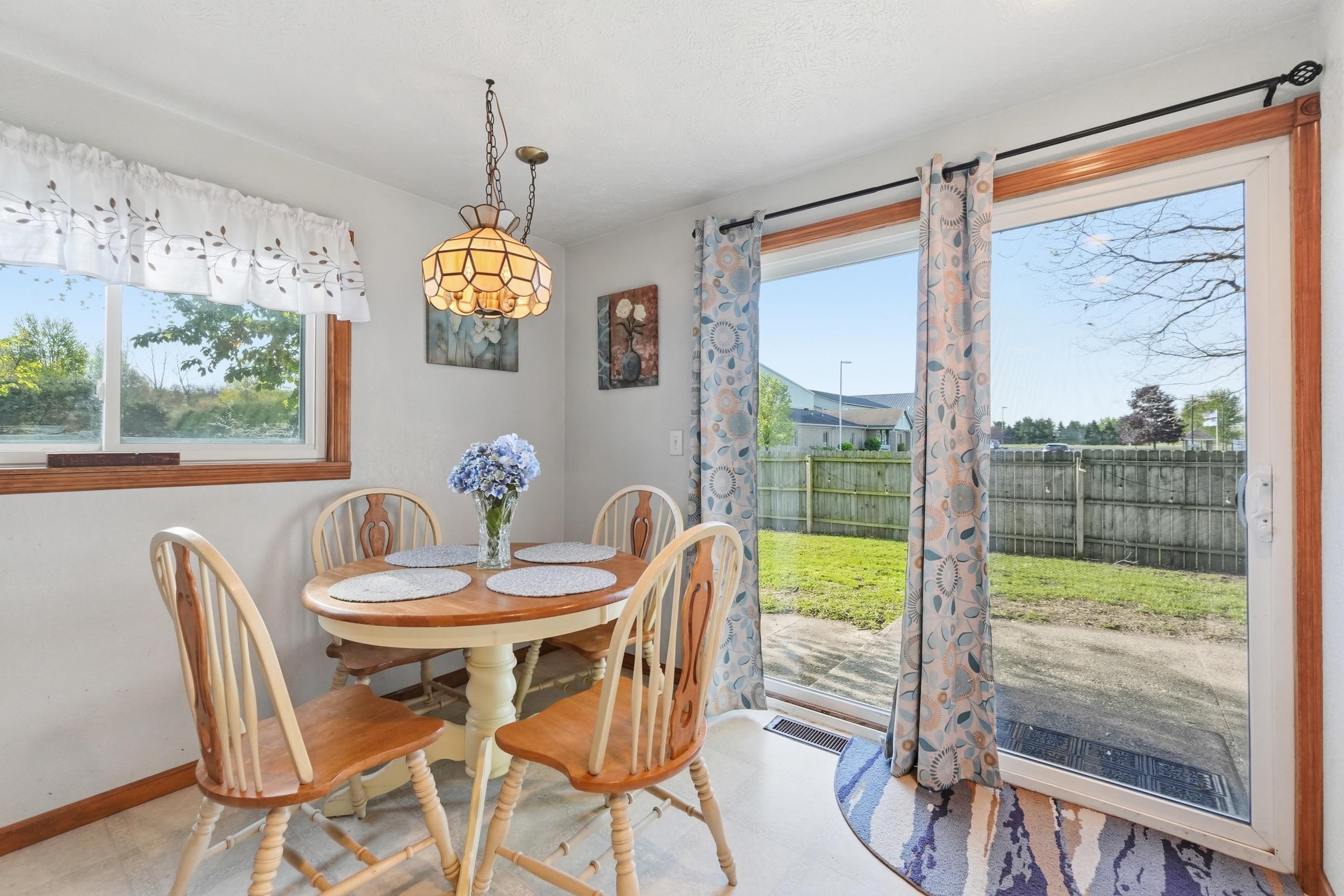 Dining area featuring a window and sliding glass door with wood trim