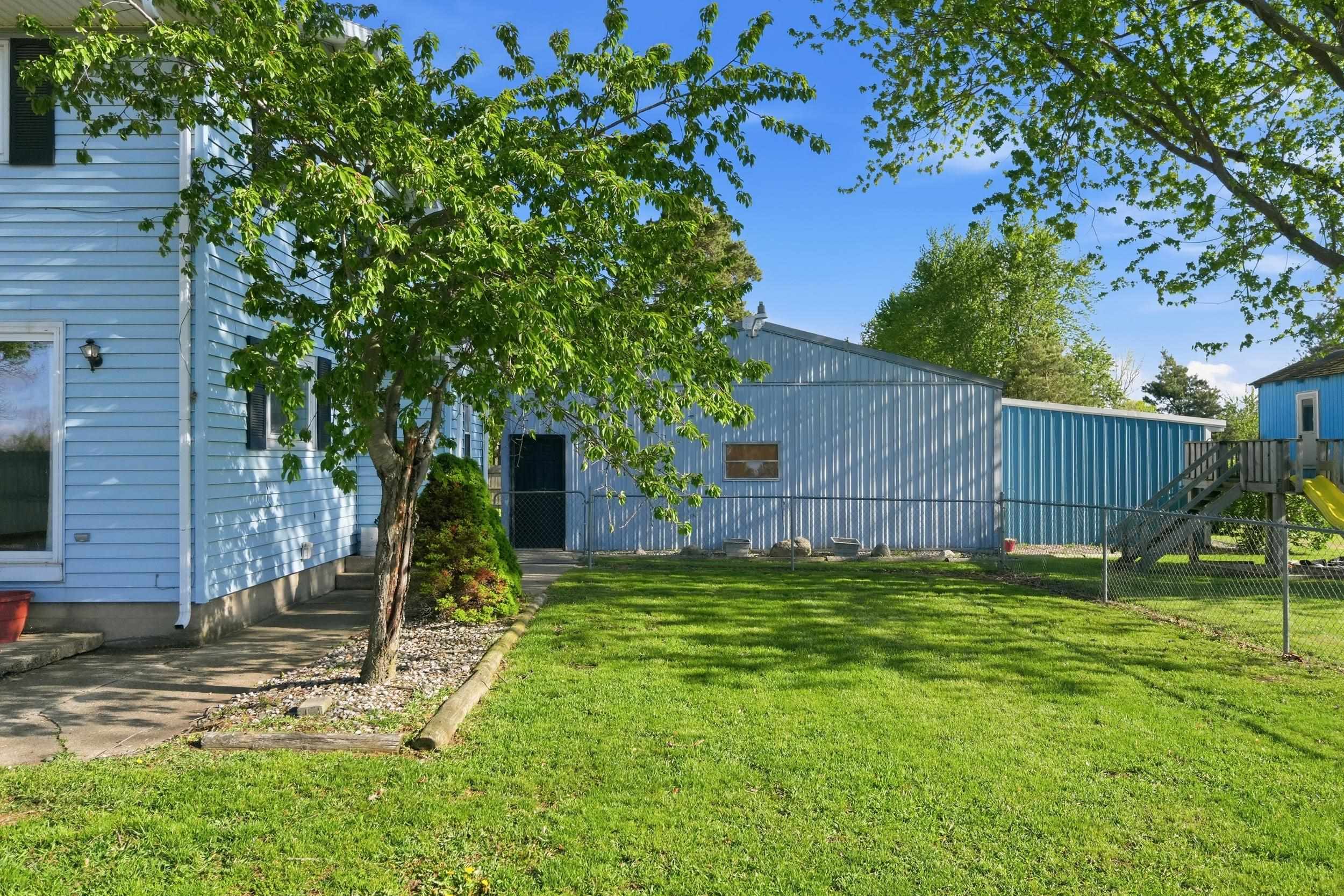 Expansive green lawn with chain link fencing