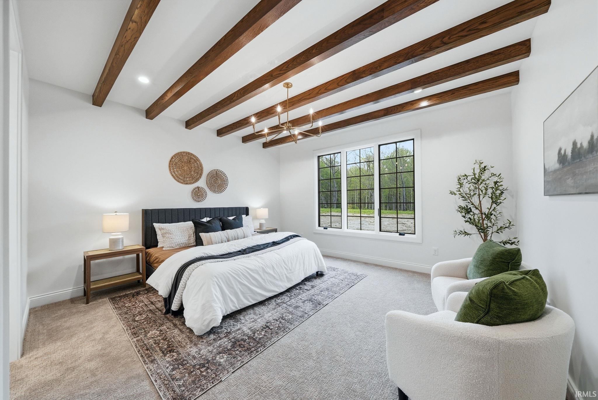 Vaulted ceiling with wood-finish beams and a linear chandelier