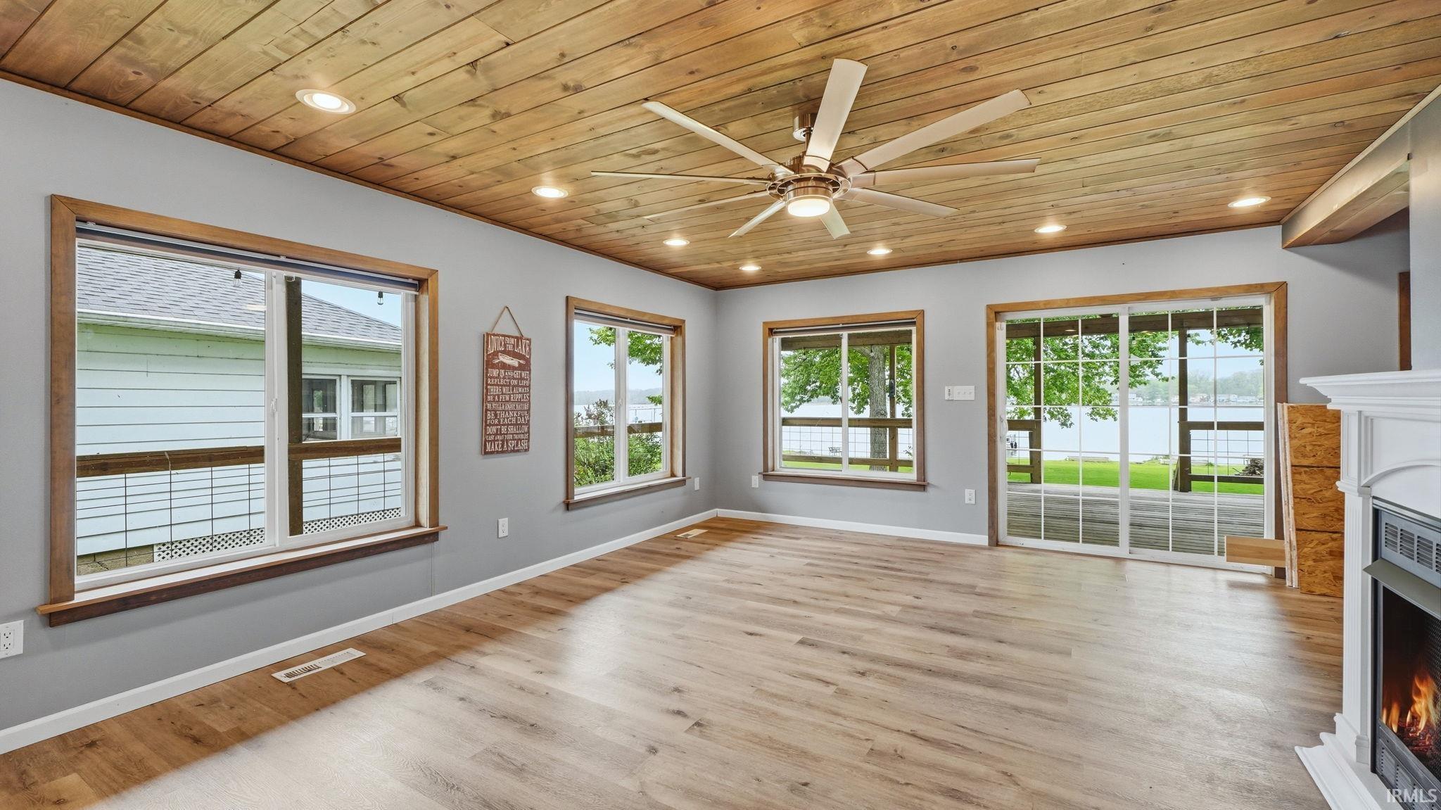 Spacious room featuring wood-finish flooring, a wood-paneled ceiling, and recessed lighting