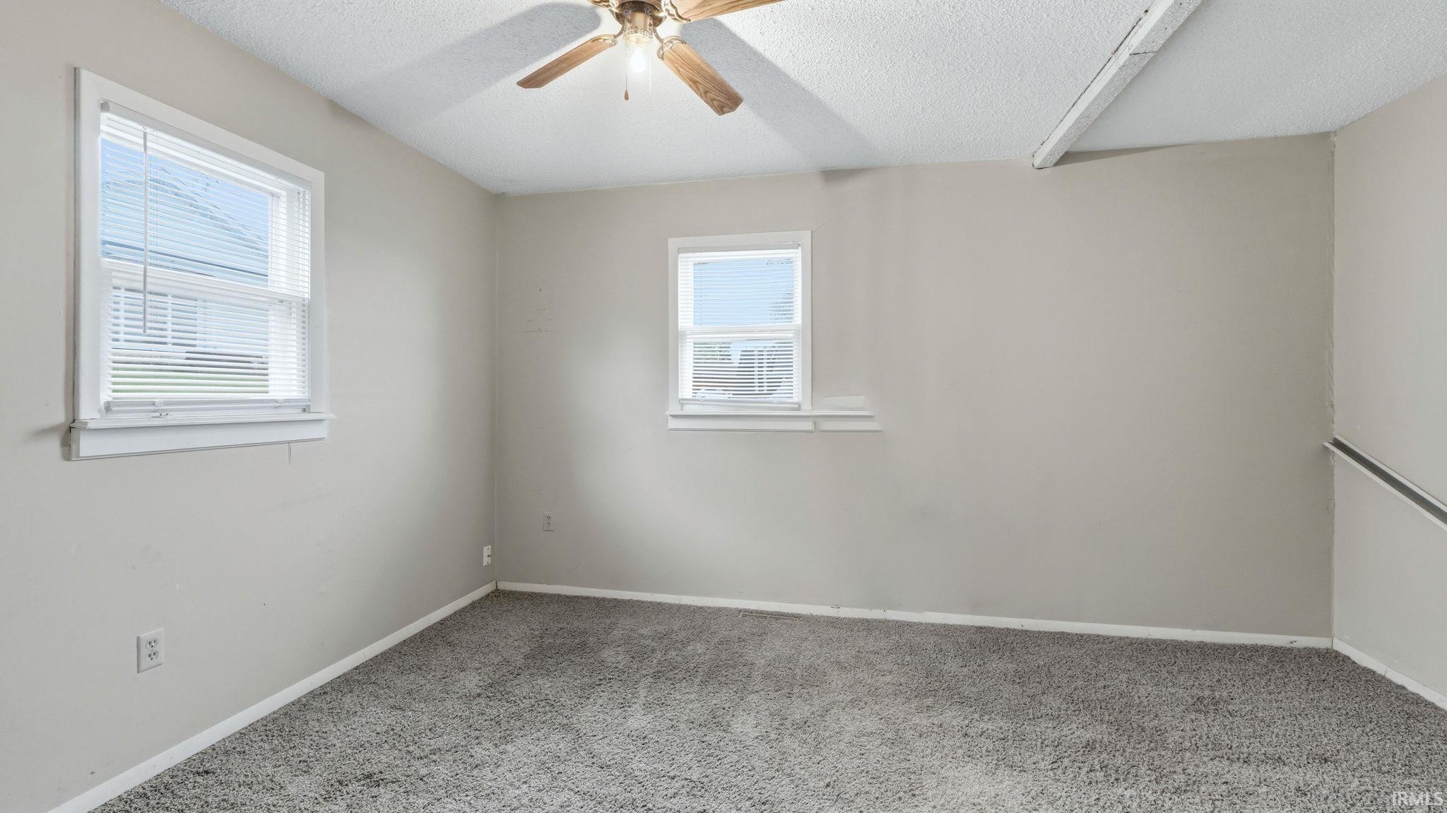 Neutral wall color, grey carpet flooring, and white trim throughout