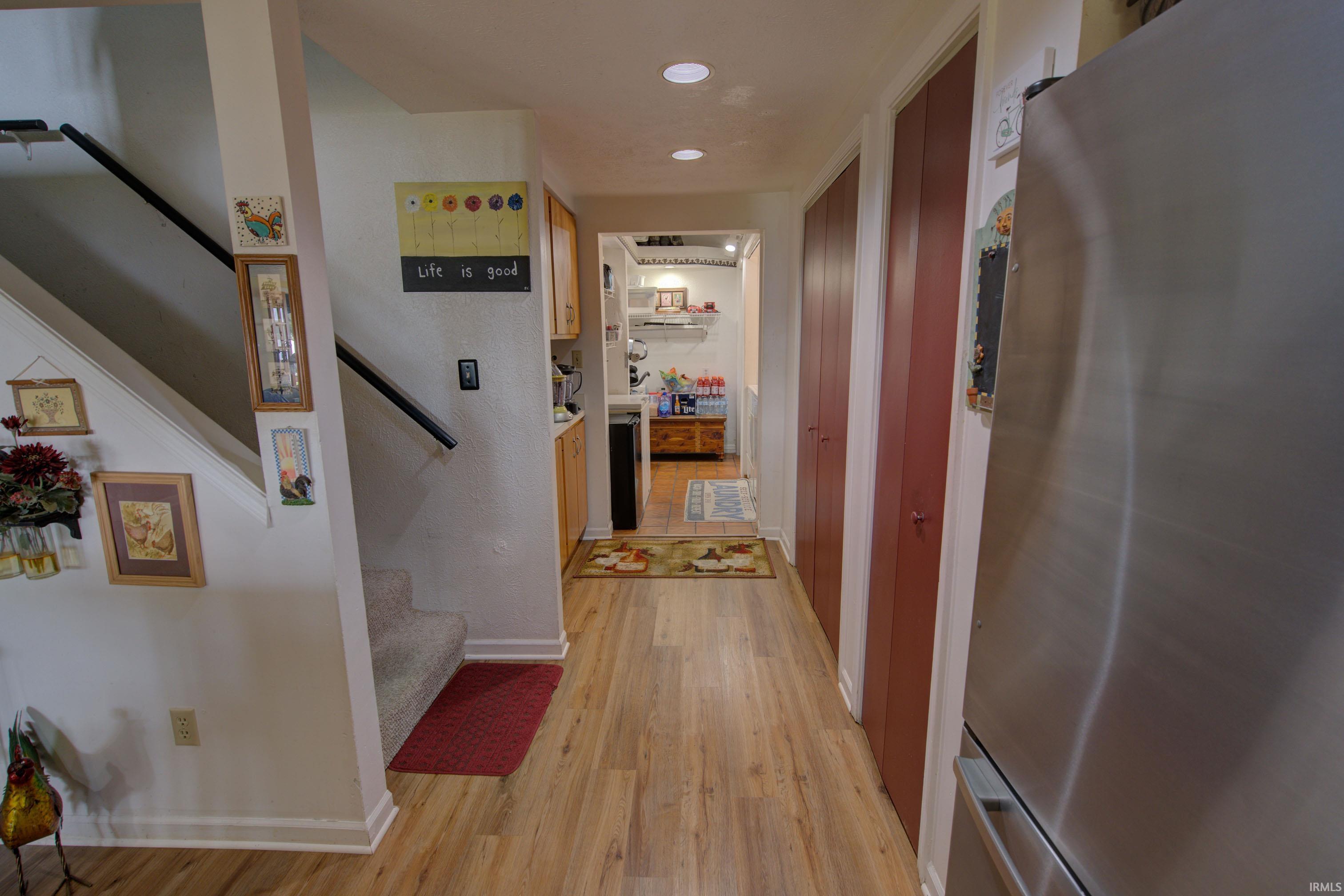 Light wood-finish flooring extending through the hallway