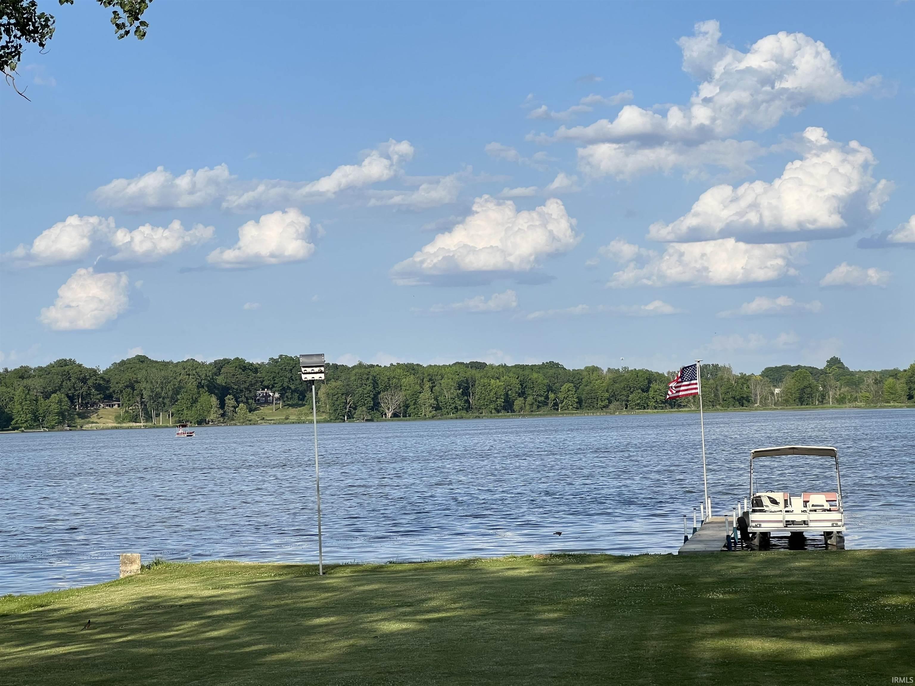 Expansive waterfront lawn with a private dock