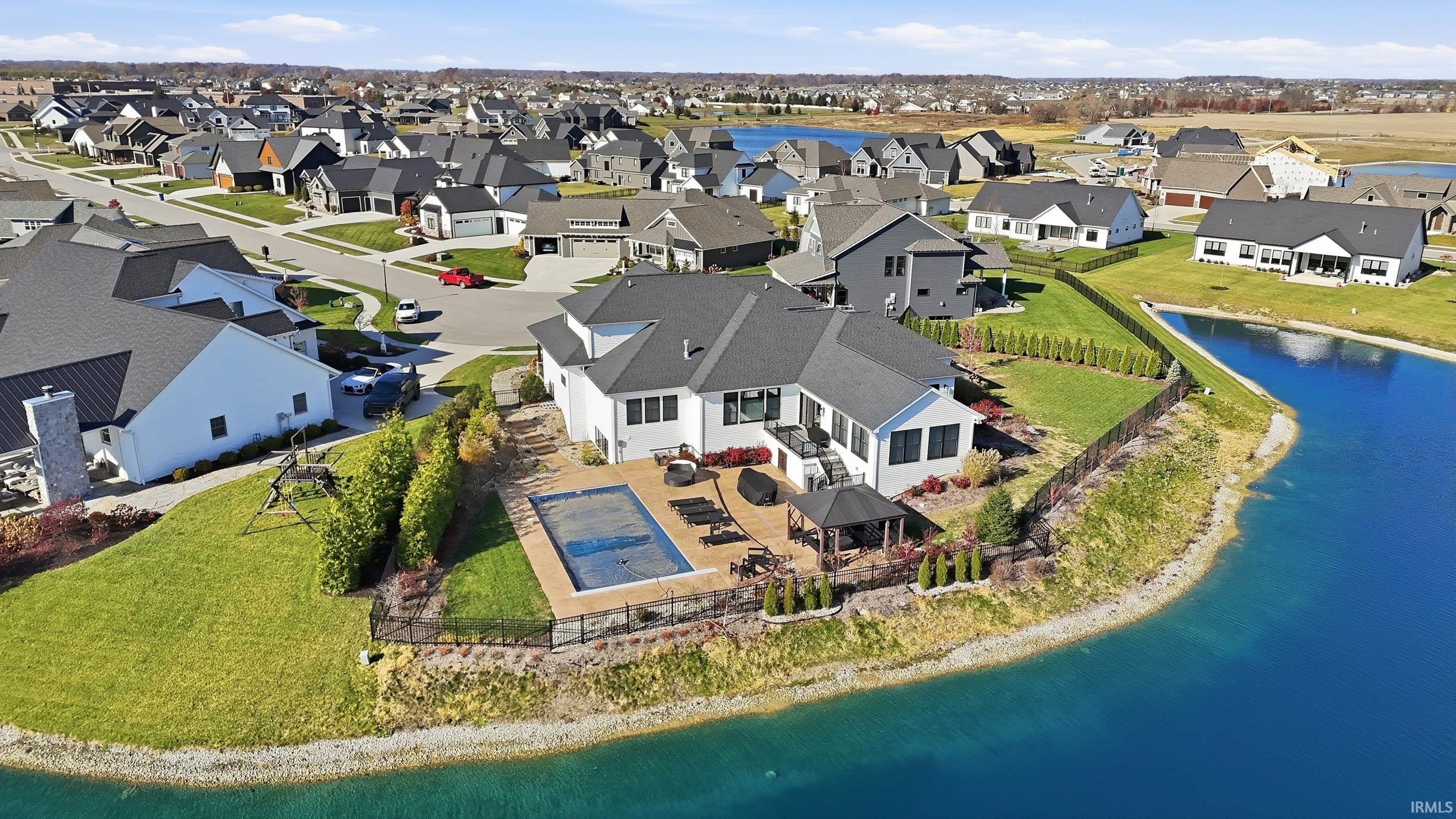 Modern residence with a private pool, extensive patio space, and direct water frontage