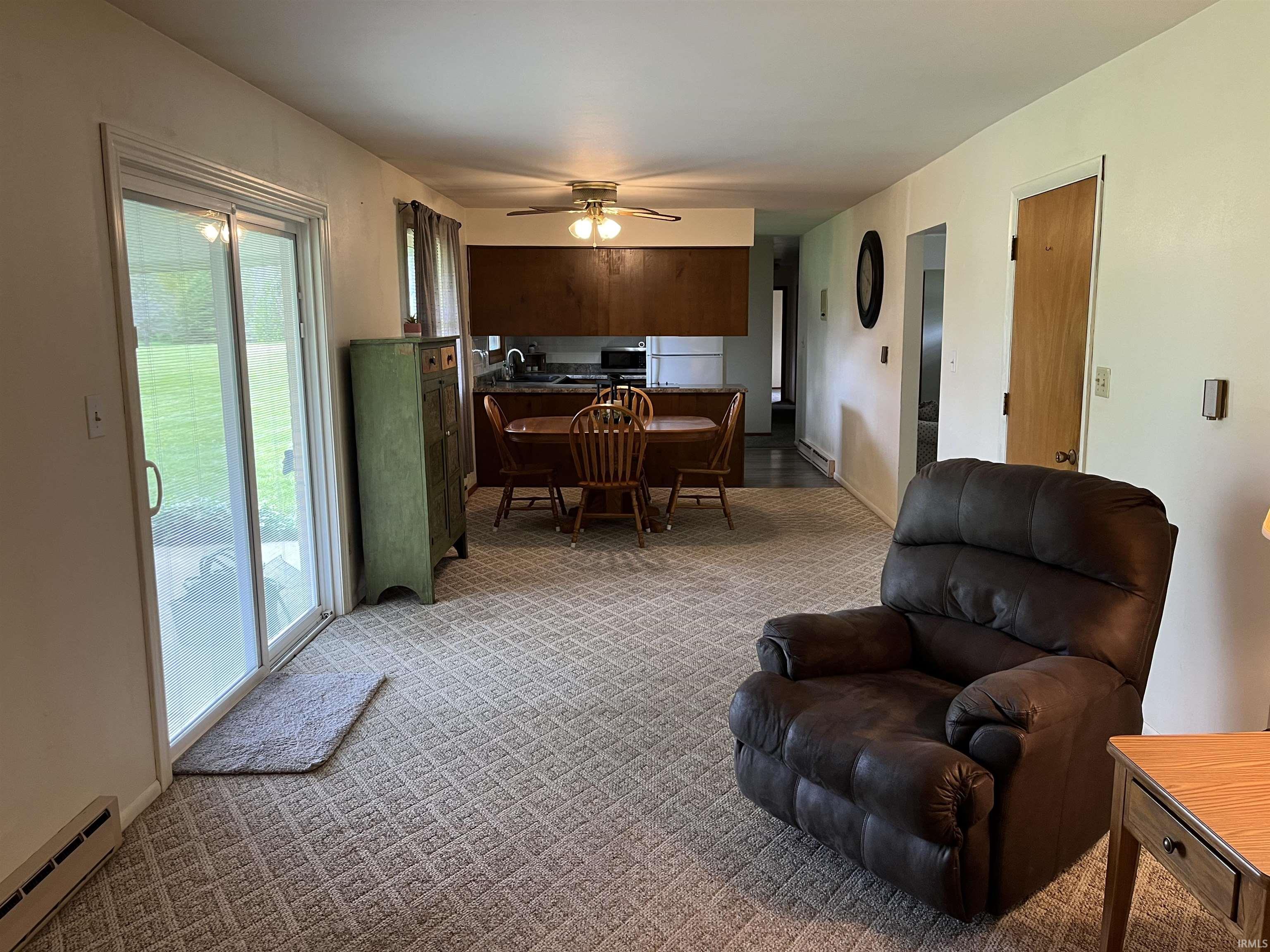 Open-concept living area with patterned carpet flooring