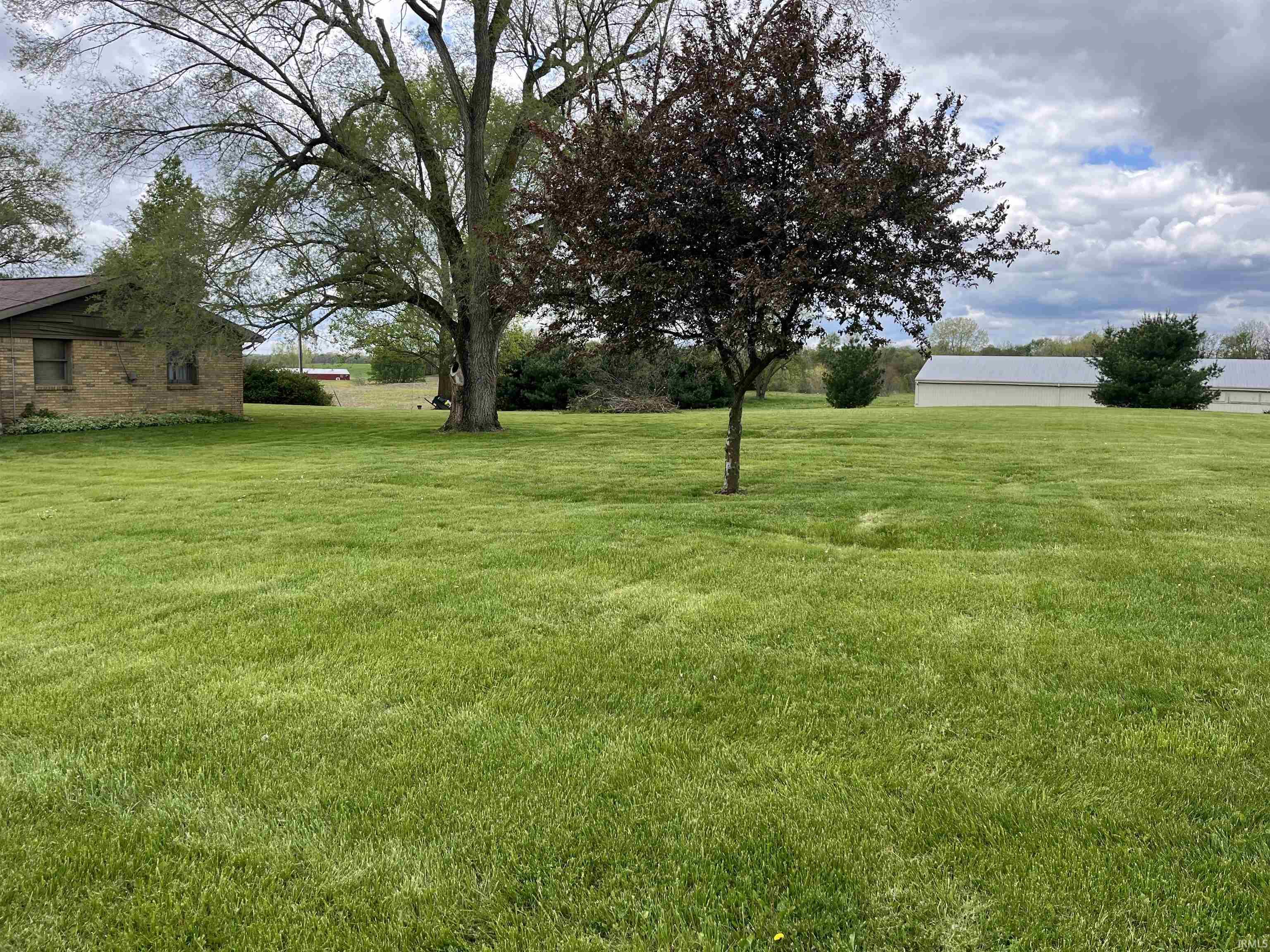 Expansive green lawn with mature trees