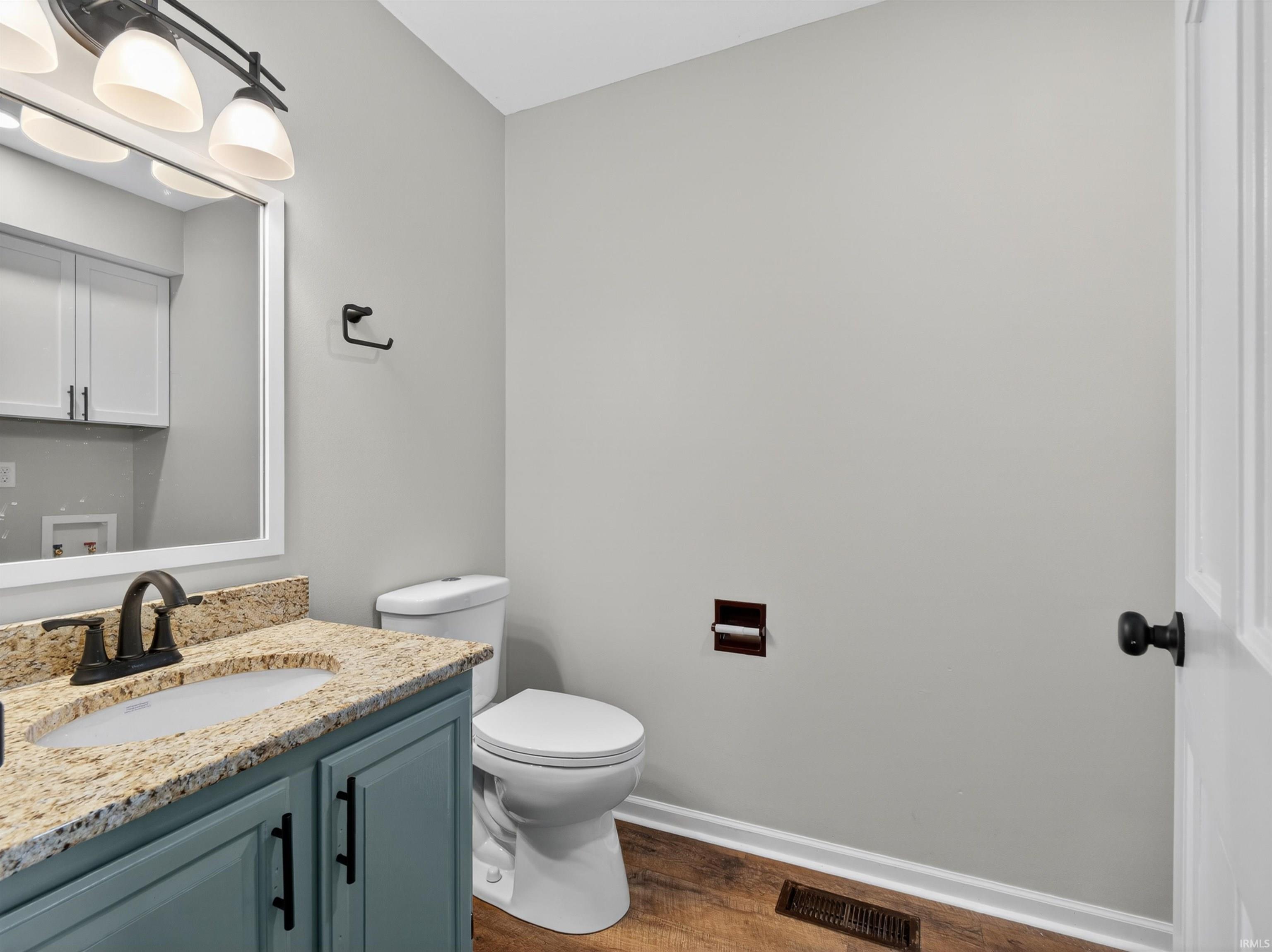 Vanity featuring a light-colored granite countertop, undermount sink, and a dark bronze faucet
