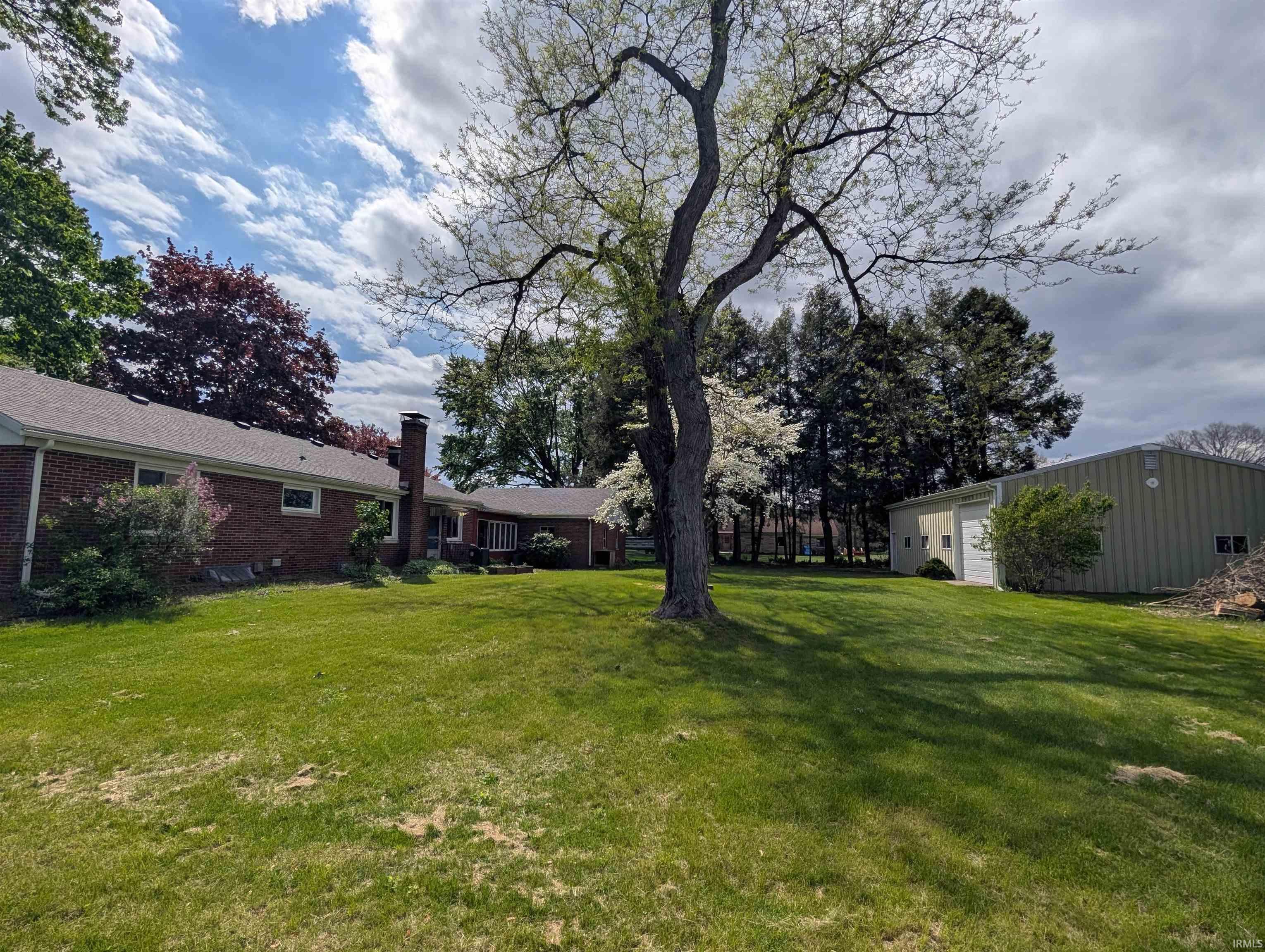 Expansive green lawn with mature trees