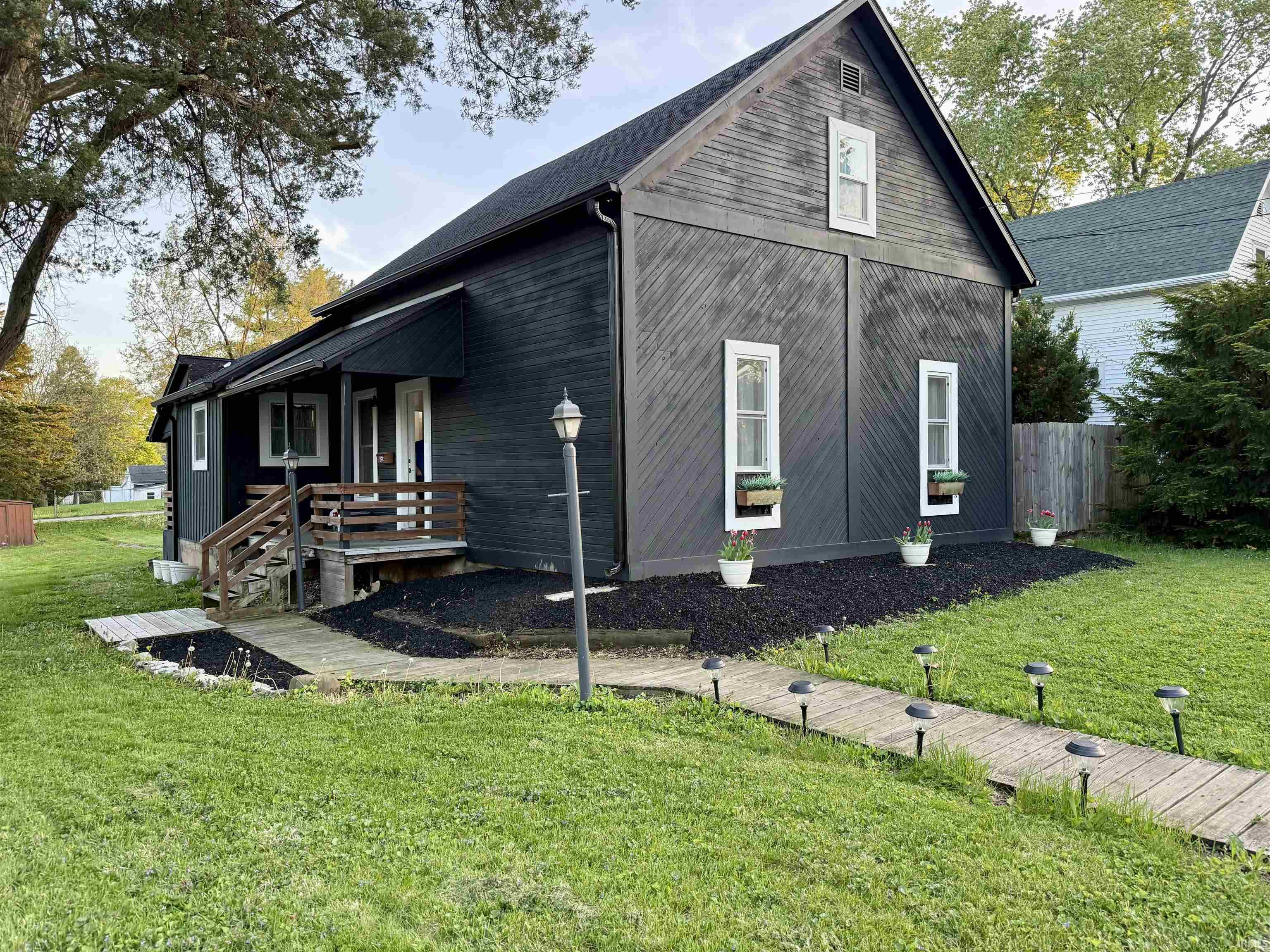 Black exterior siding with contrasting white window trim