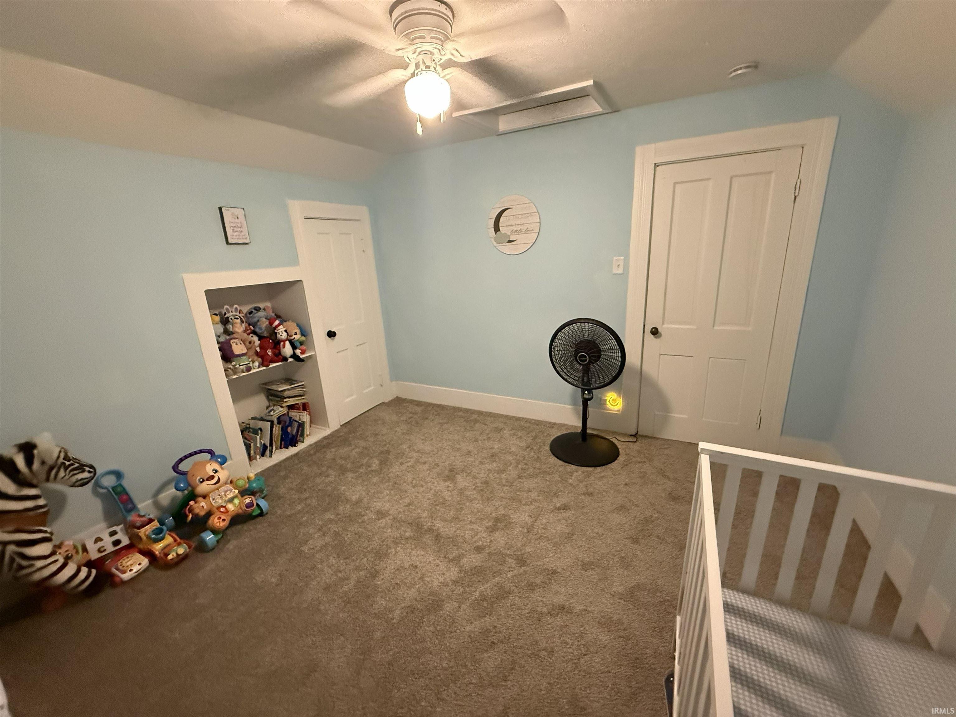 Bedroom featuring light blue walls, gray carpeting, a ceiling fan with integrated lighting