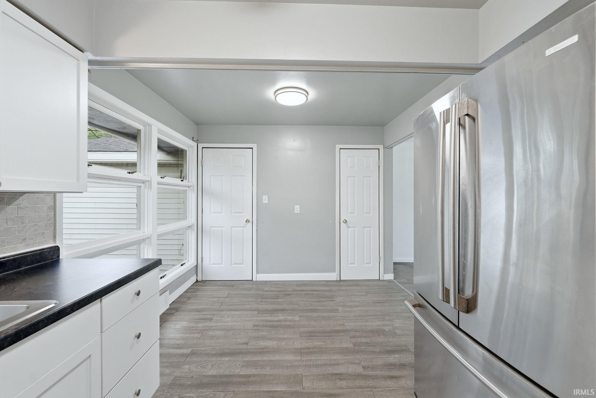 Kitchen area with wood-finish flooring and light gray walls
