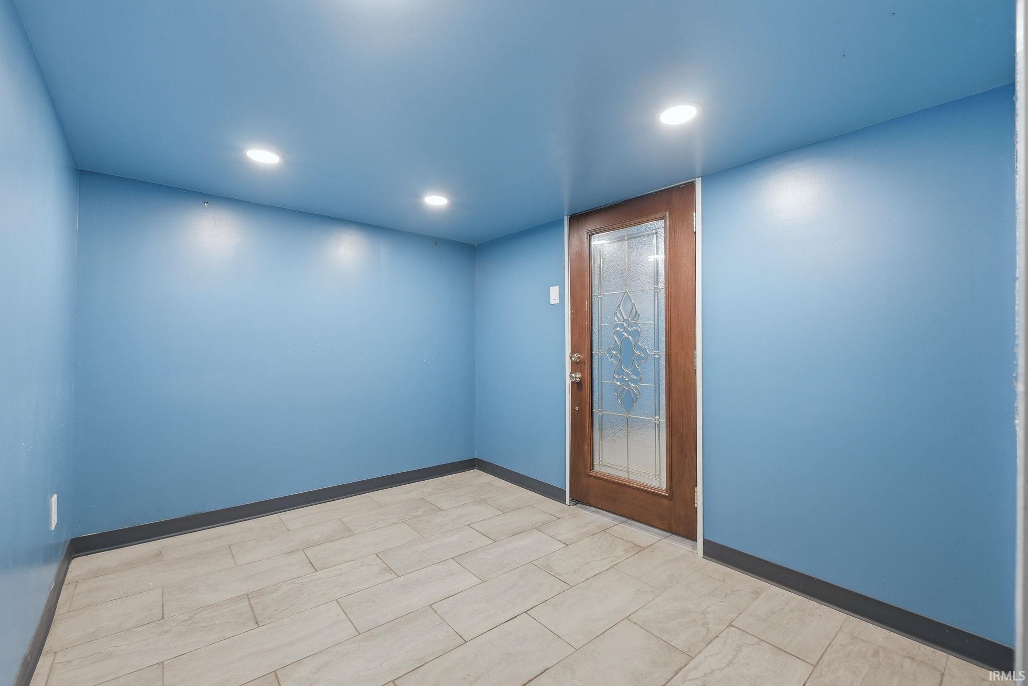 Interior room featuring light blue walls and recessed ceiling lighting