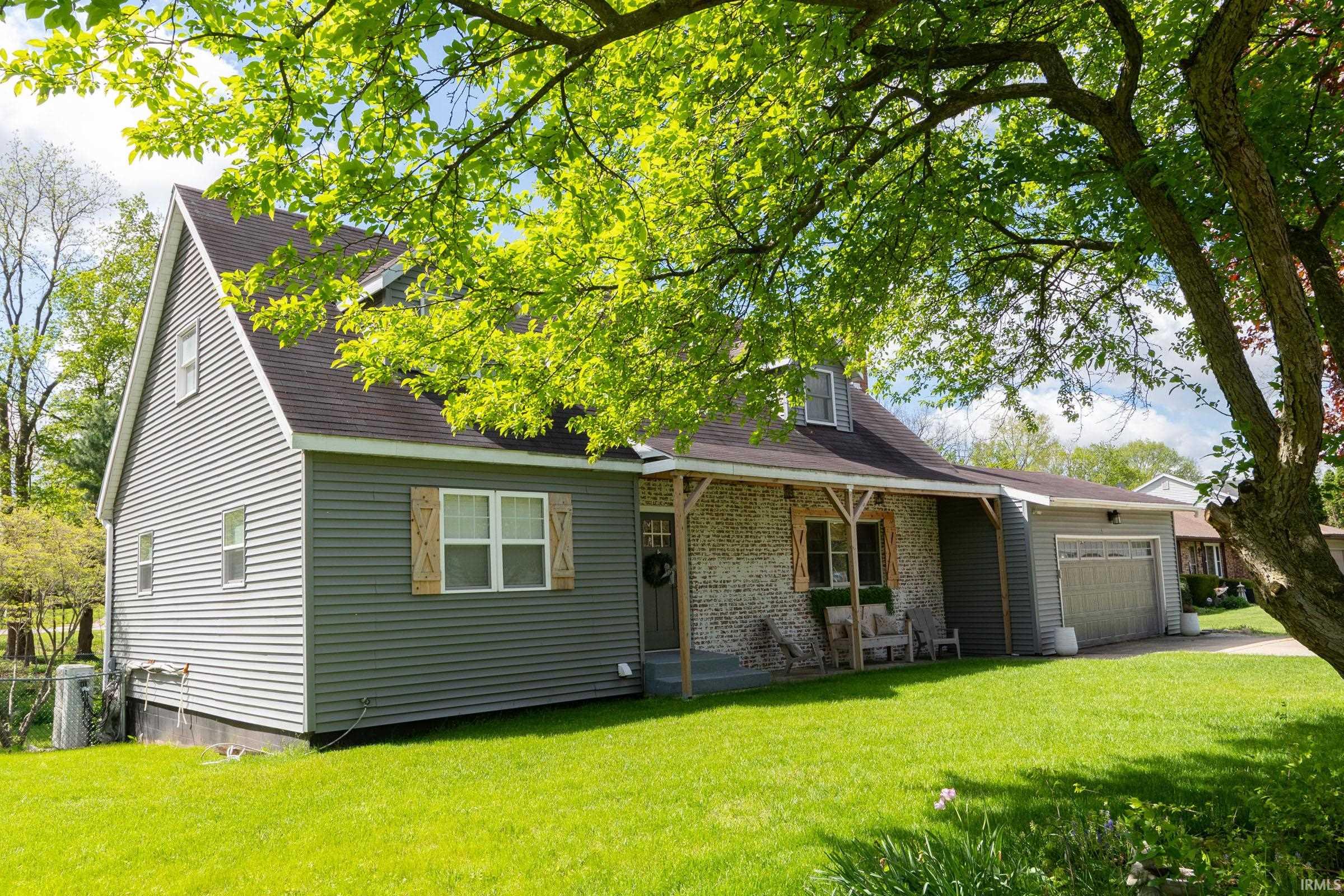 Gray siding exterior with white trim windows and decorative wood shutters