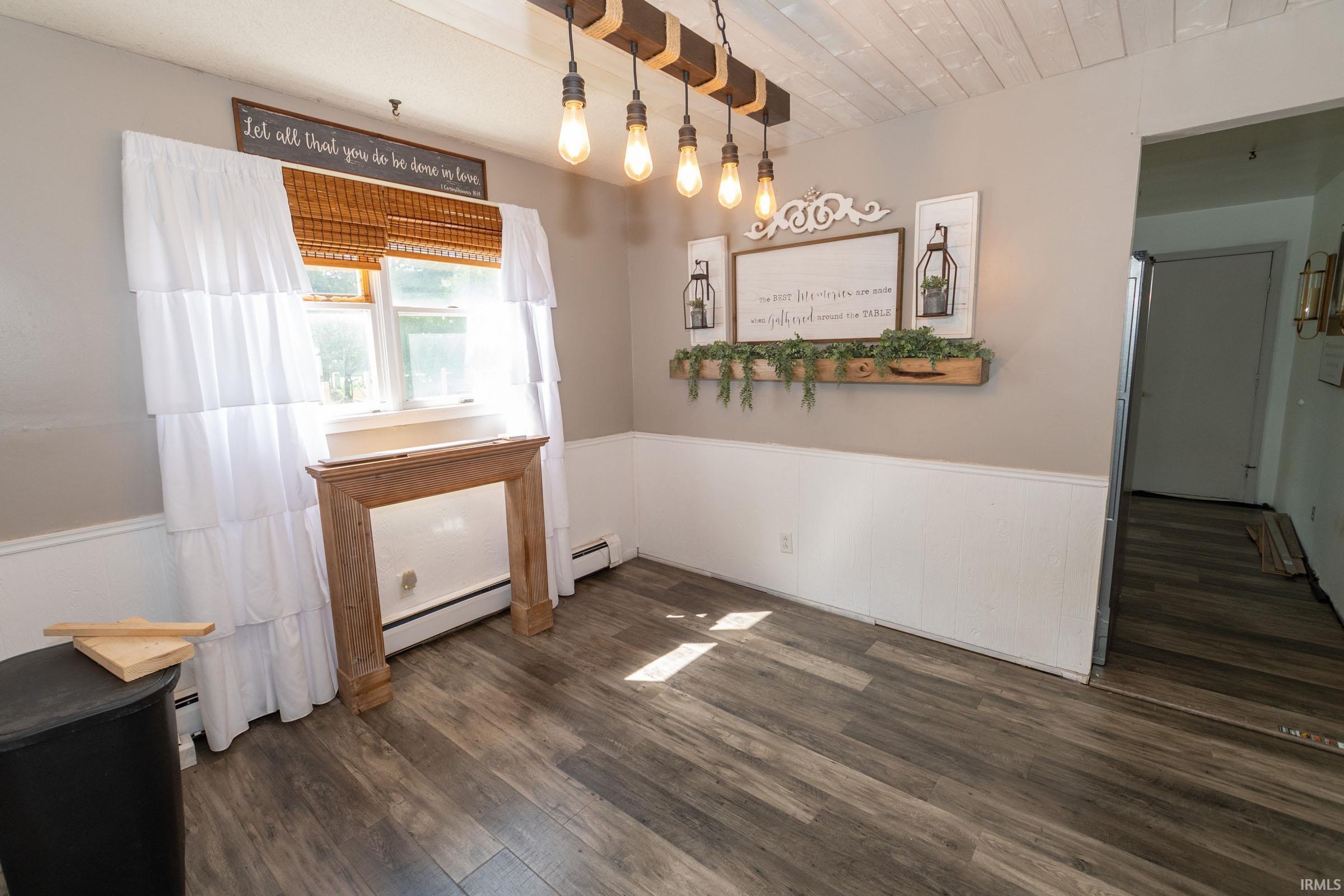Dining area featuring wood-finish flooring and a white shiplap ceiling