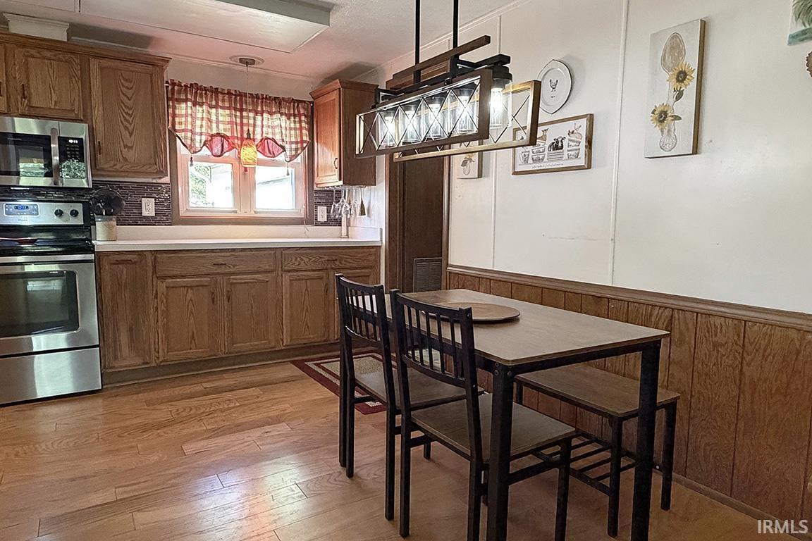 Kitchen area featuring wood-finish flooring and wood cabinetry