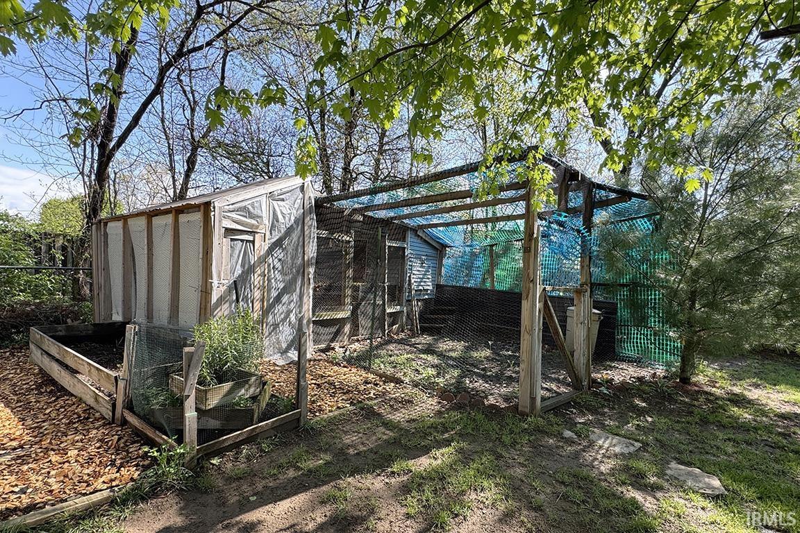 Outdoor structure featuring wood framing and wire mesh enclosure