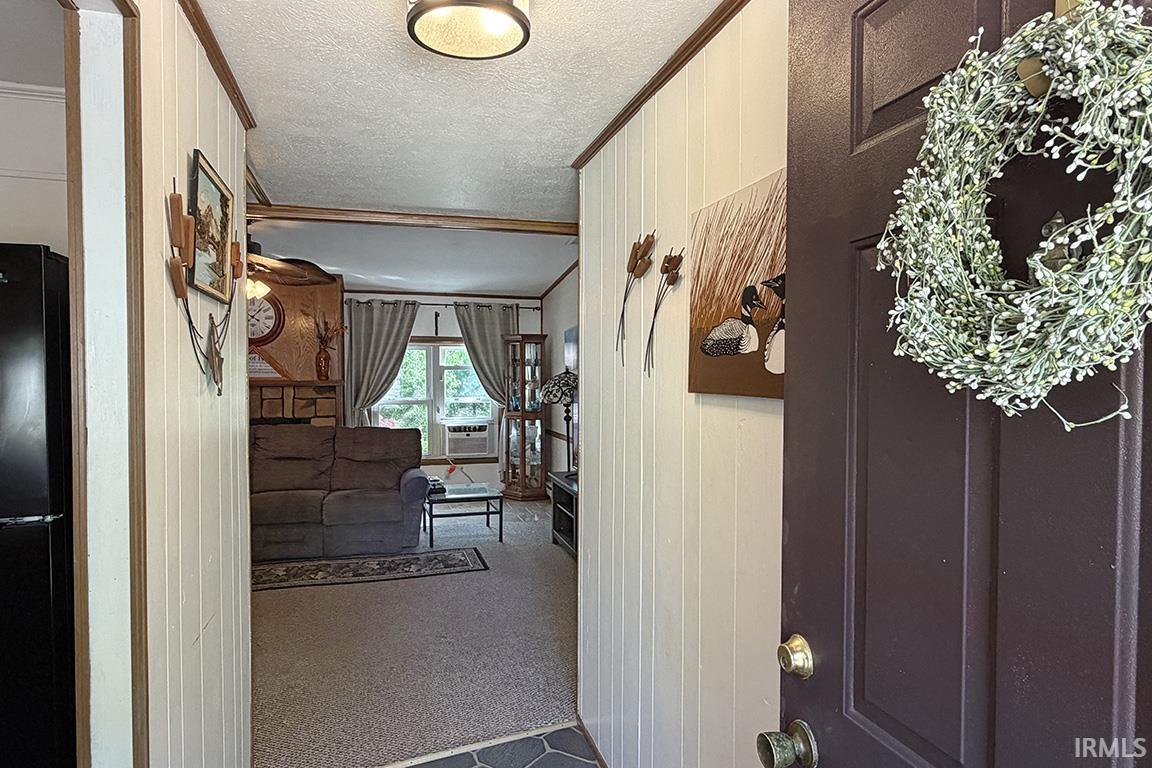 Entryway with vertical paneling and wood-finish trim