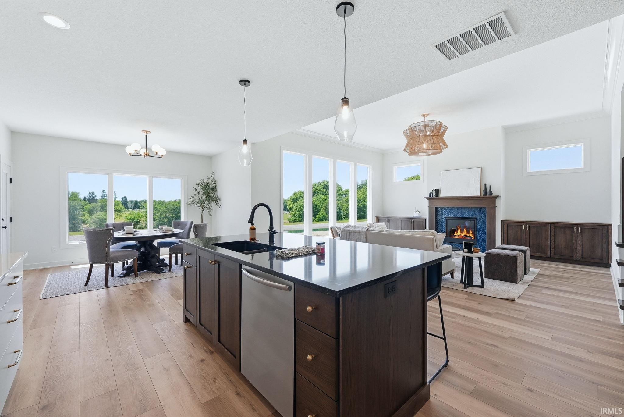 Spacious open-concept interior featuring light wood-finish flooring