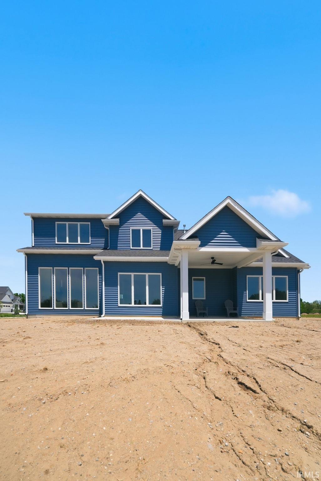 Blue siding exterior featuring multiple gables and white trim