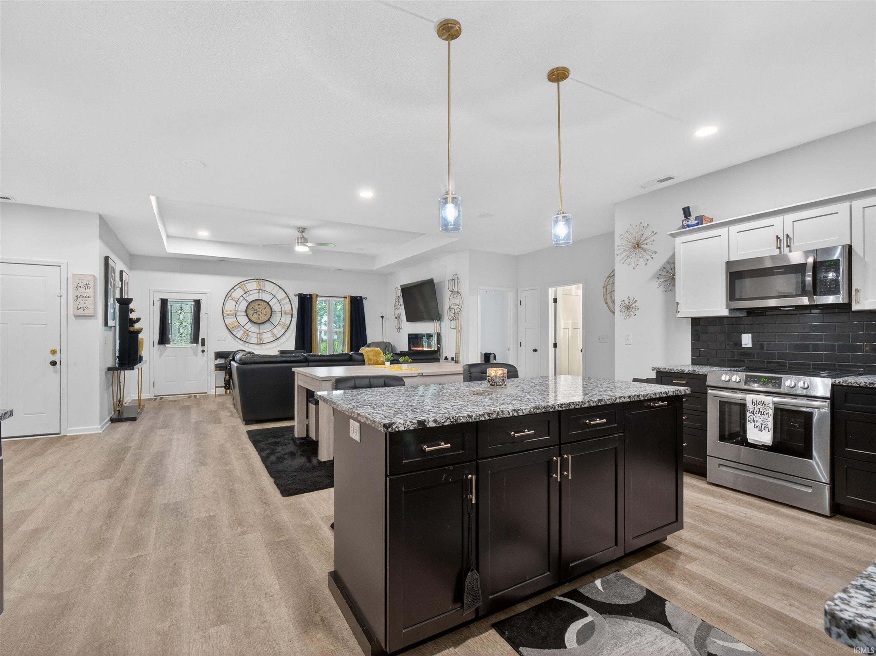 Kitchen island with granite countertop and pendant lighting