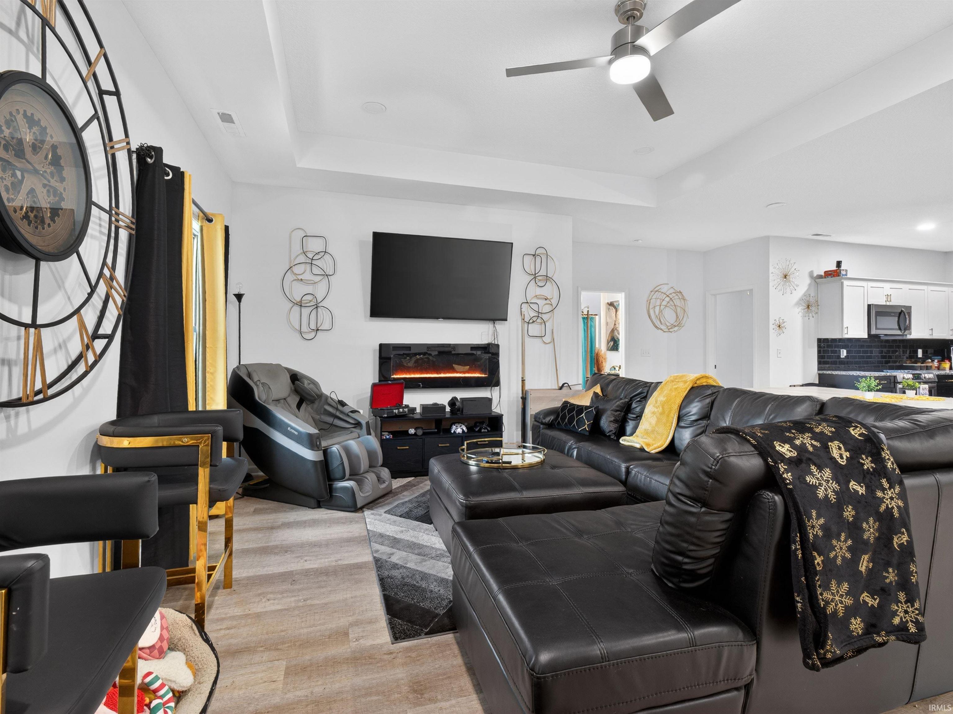 Spacious living area featuring wood-finish flooring, recessed lighting, and a modern ceiling fan