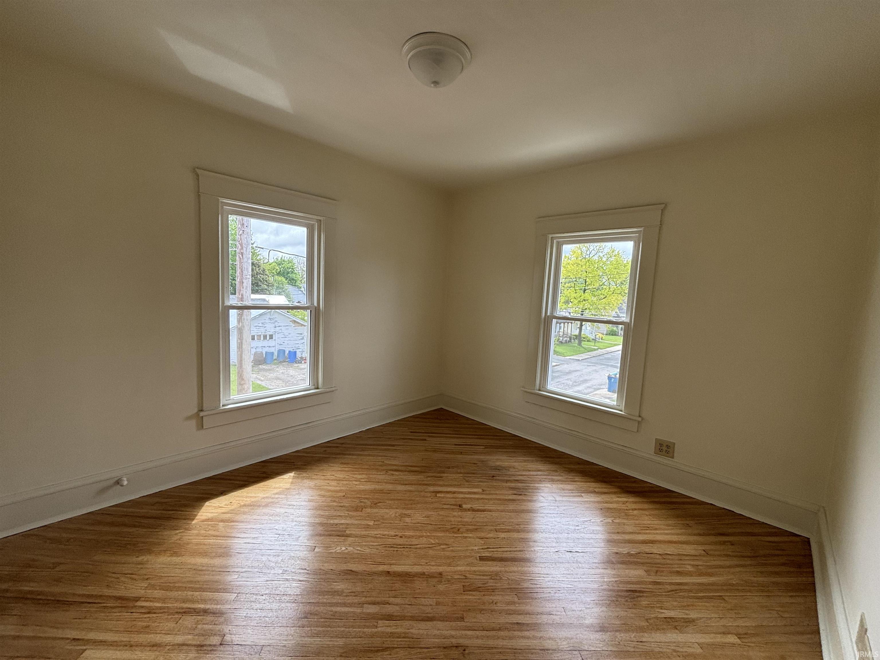 Hardwood flooring complements neutral wall tones and white trim