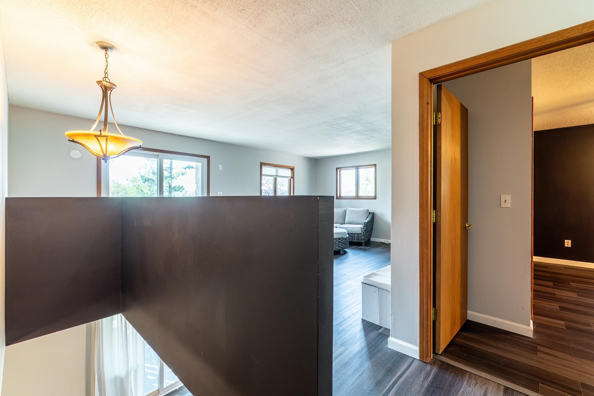 Open concept interior featuring dark wood-finish flooring