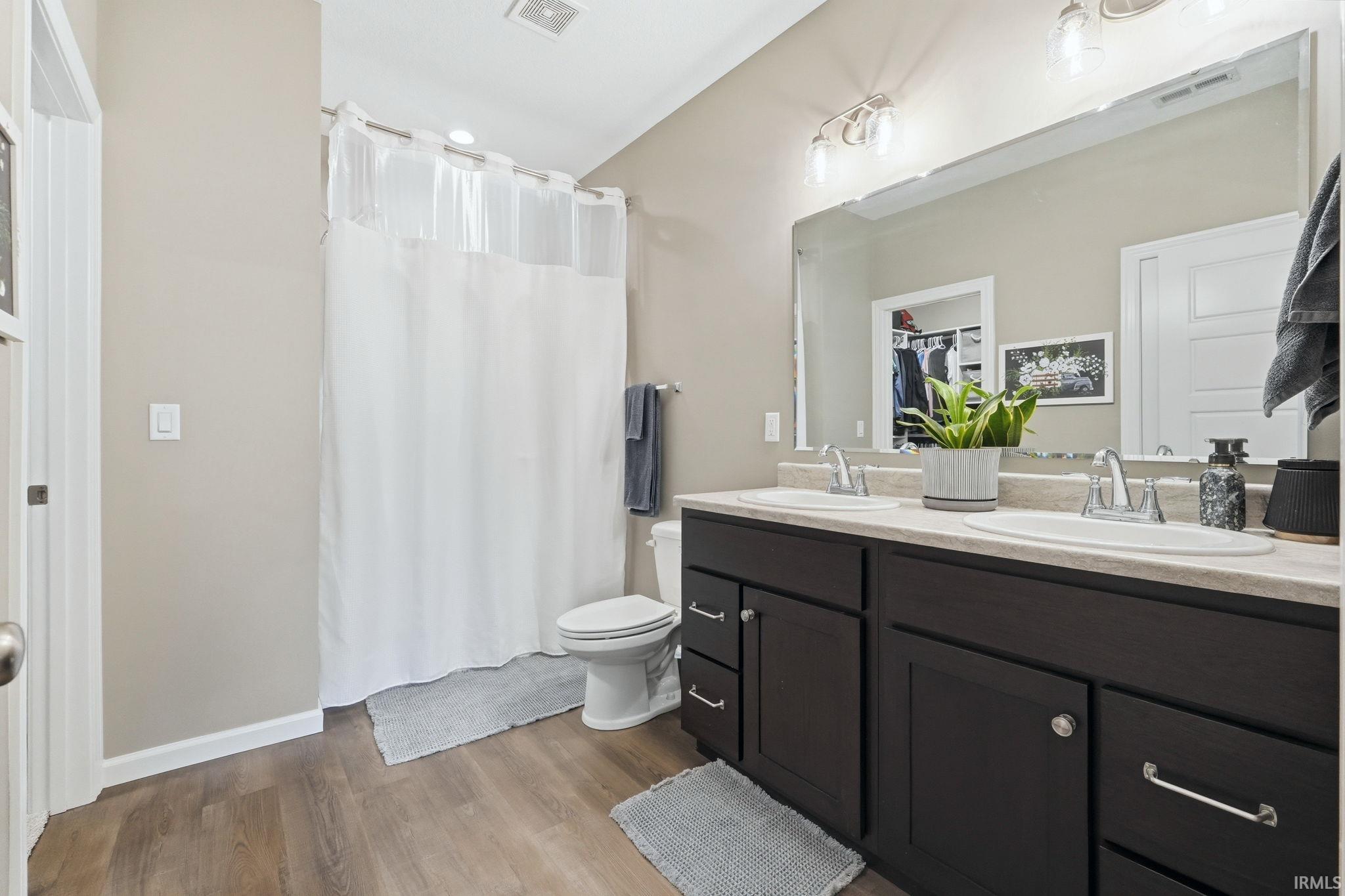 Double vanity with beautiful cabinetry, integrated sinks, and chrome fixtures