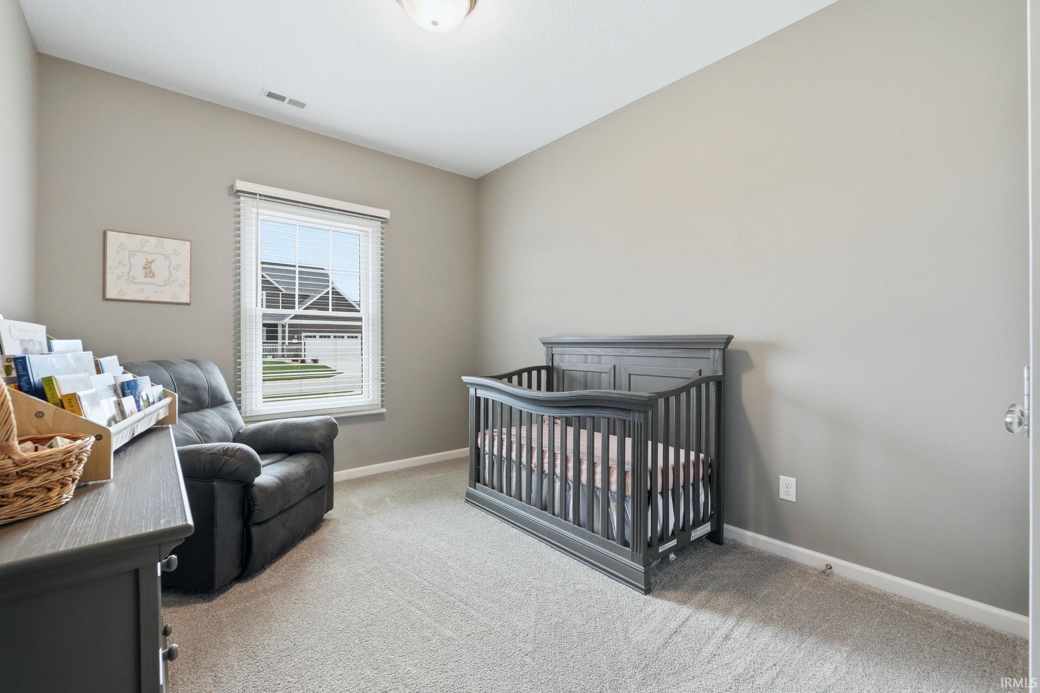 Carpeted room with neutral wall tones