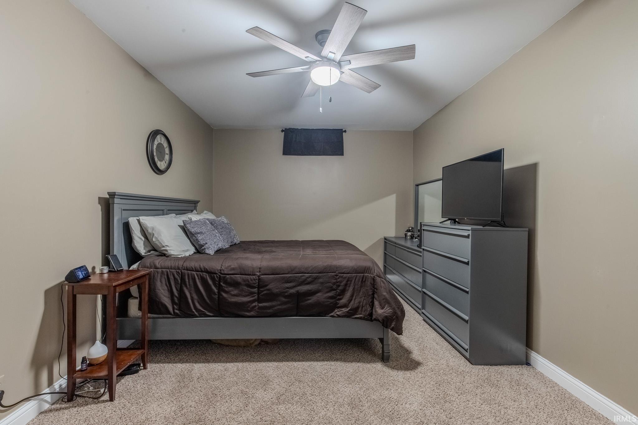 Neutral-toned walls complement the carpeted flooring