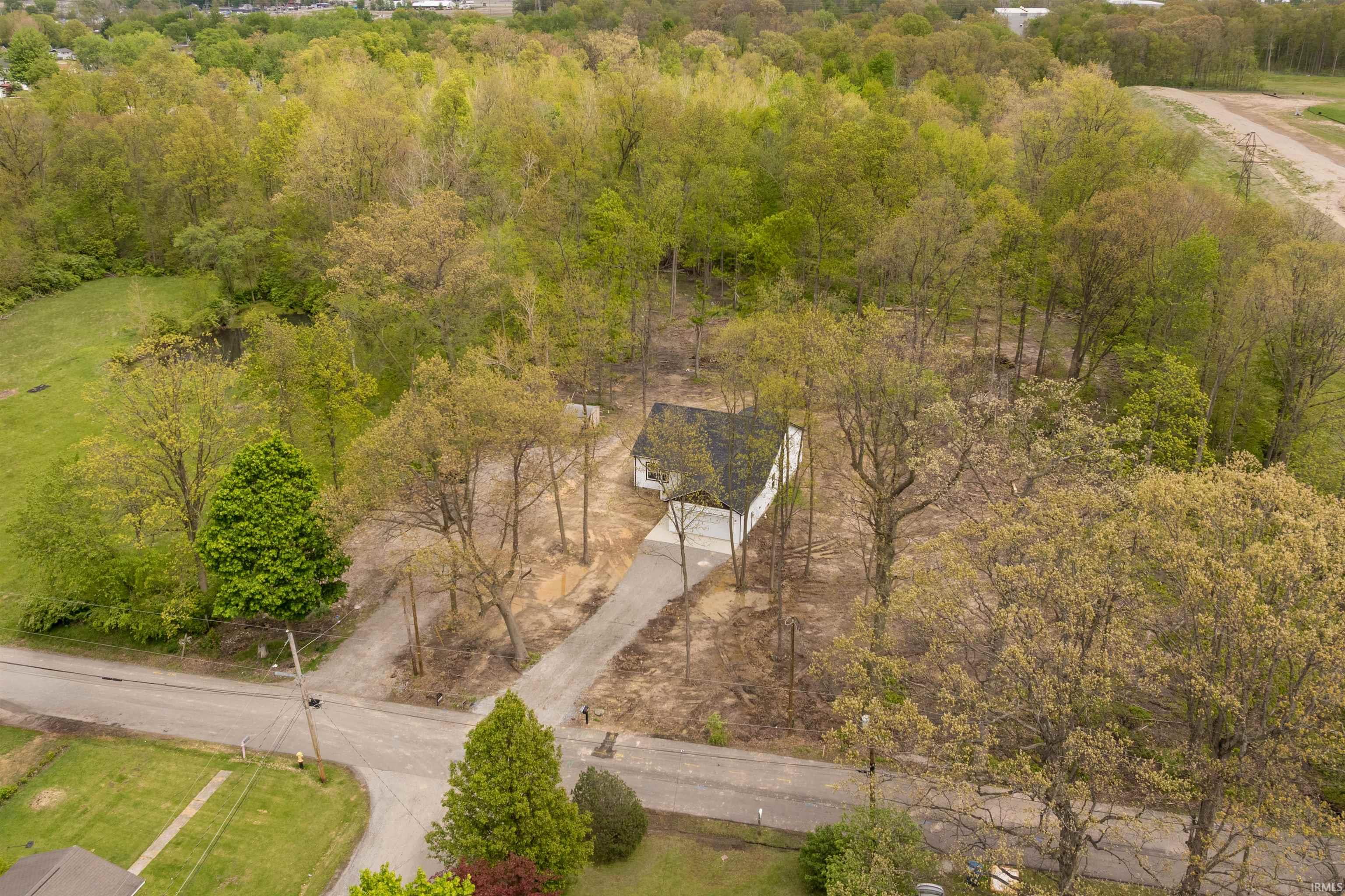 Private setting with extensive tree coverage and a gravel driveway