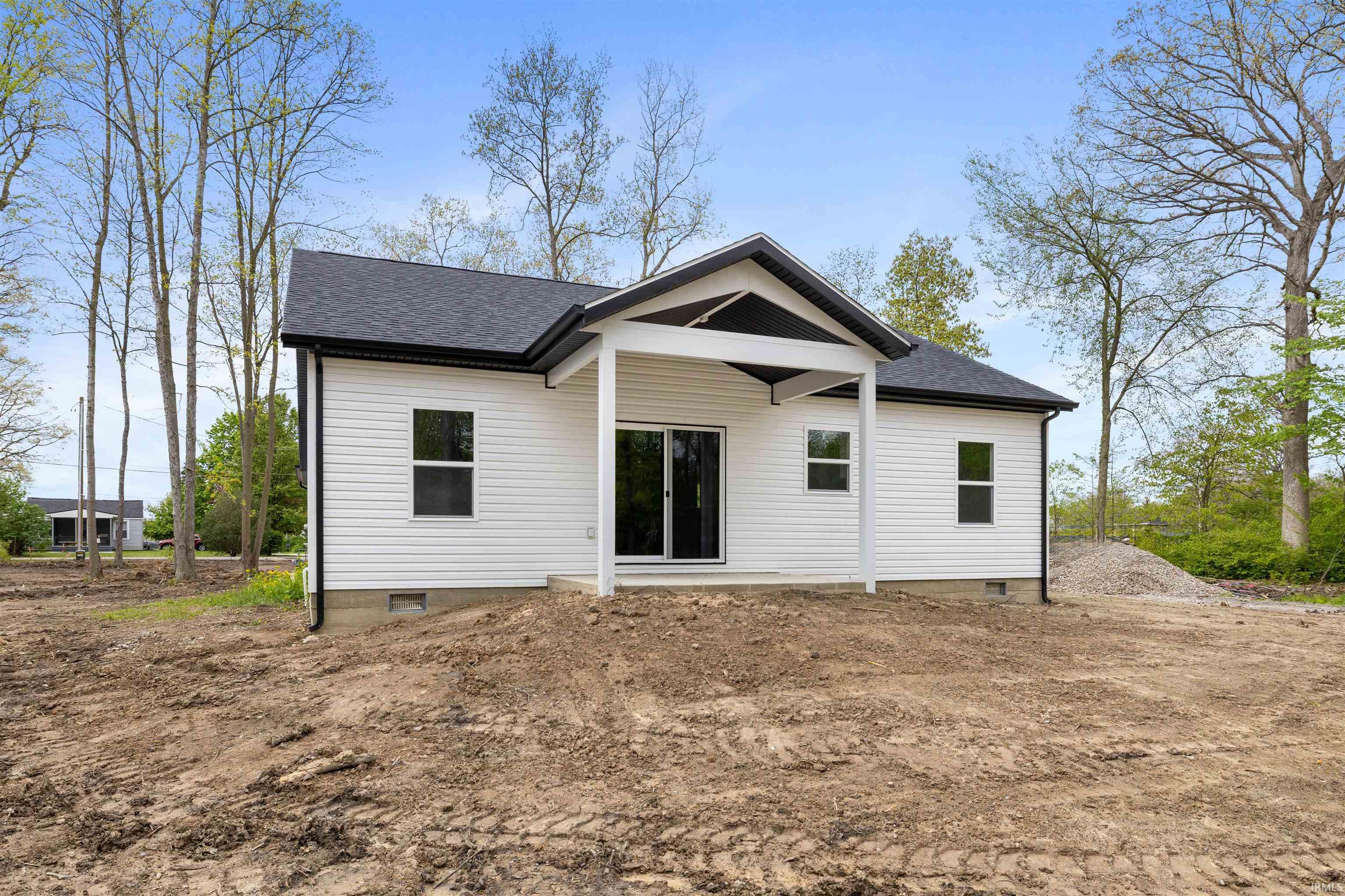 Contemporary single-story residence featuring white horizontal siding and a dark shingle roof