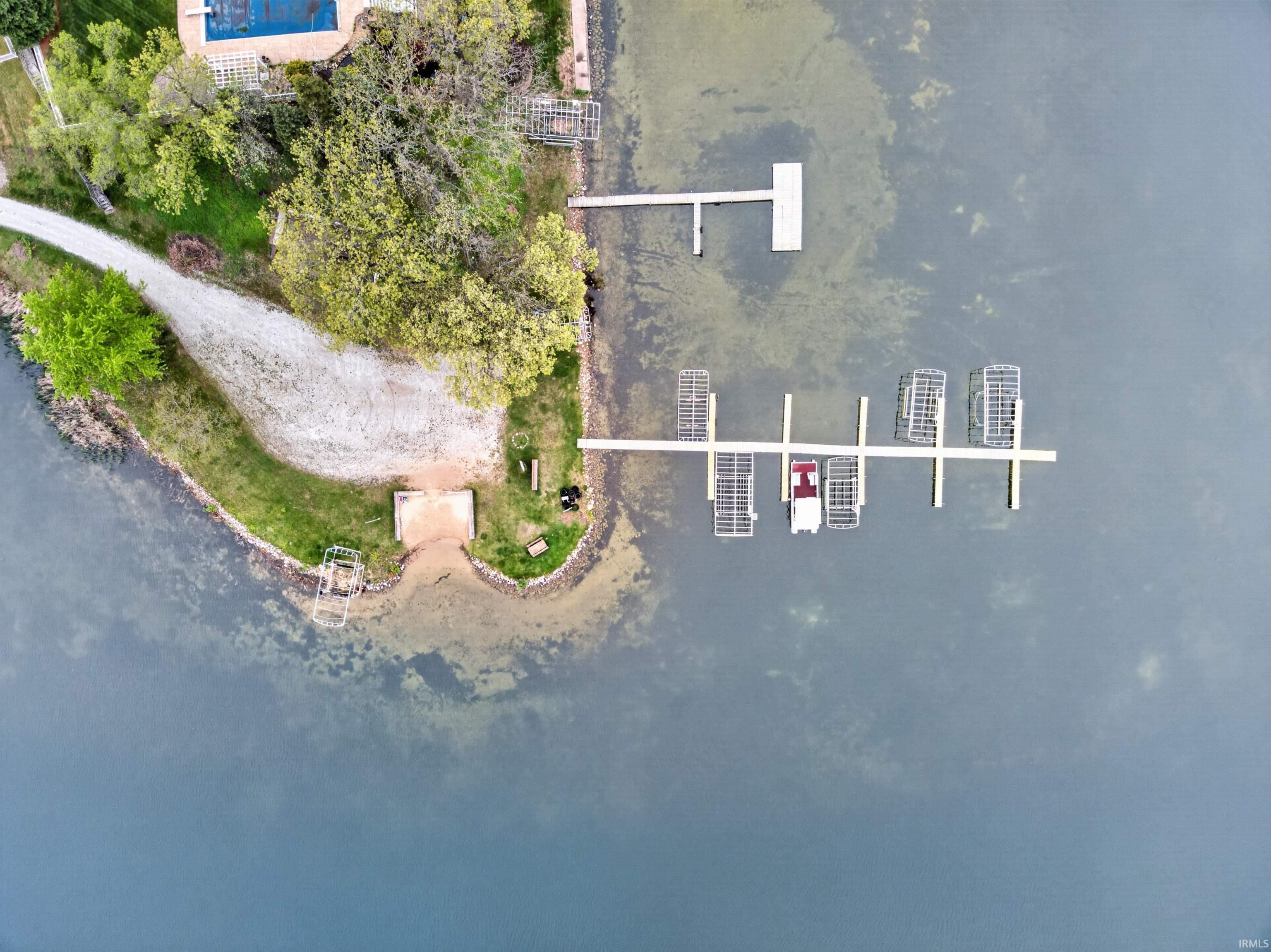 Waterfront property featuring multiple boat slips, a private dock, and a dedicated boat launch