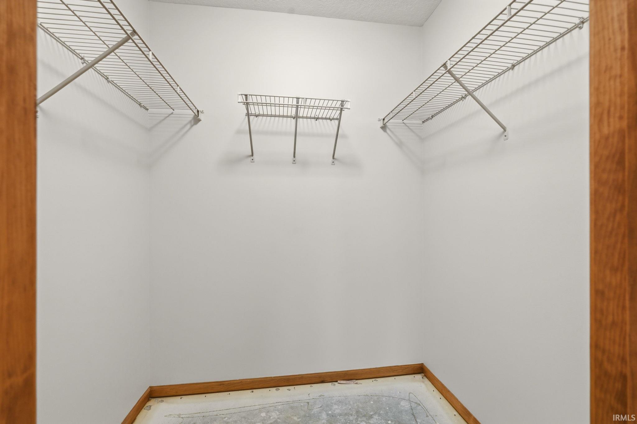 Spacious closet featuring white wire shelving