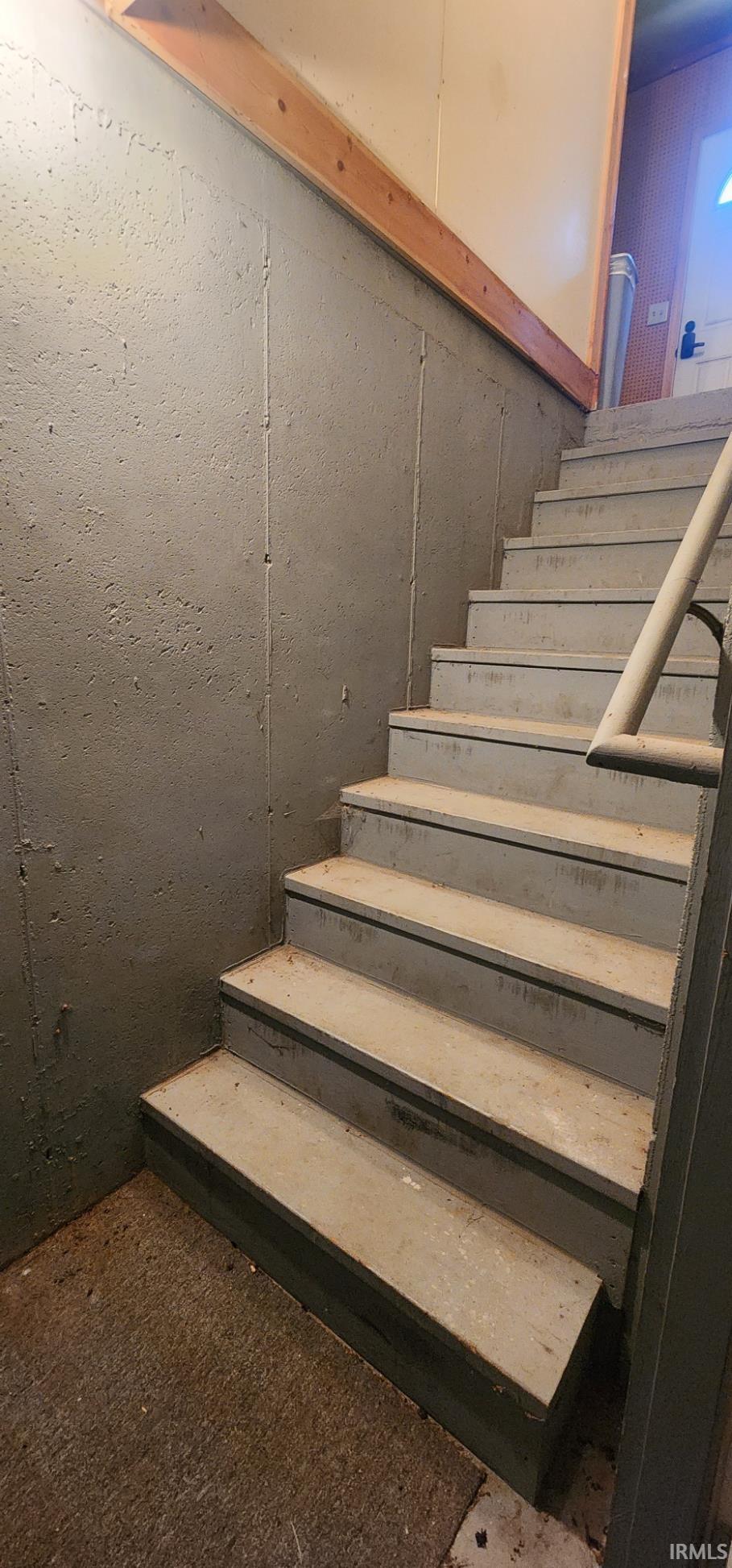 Concrete staircase featuring painted treads and risers
