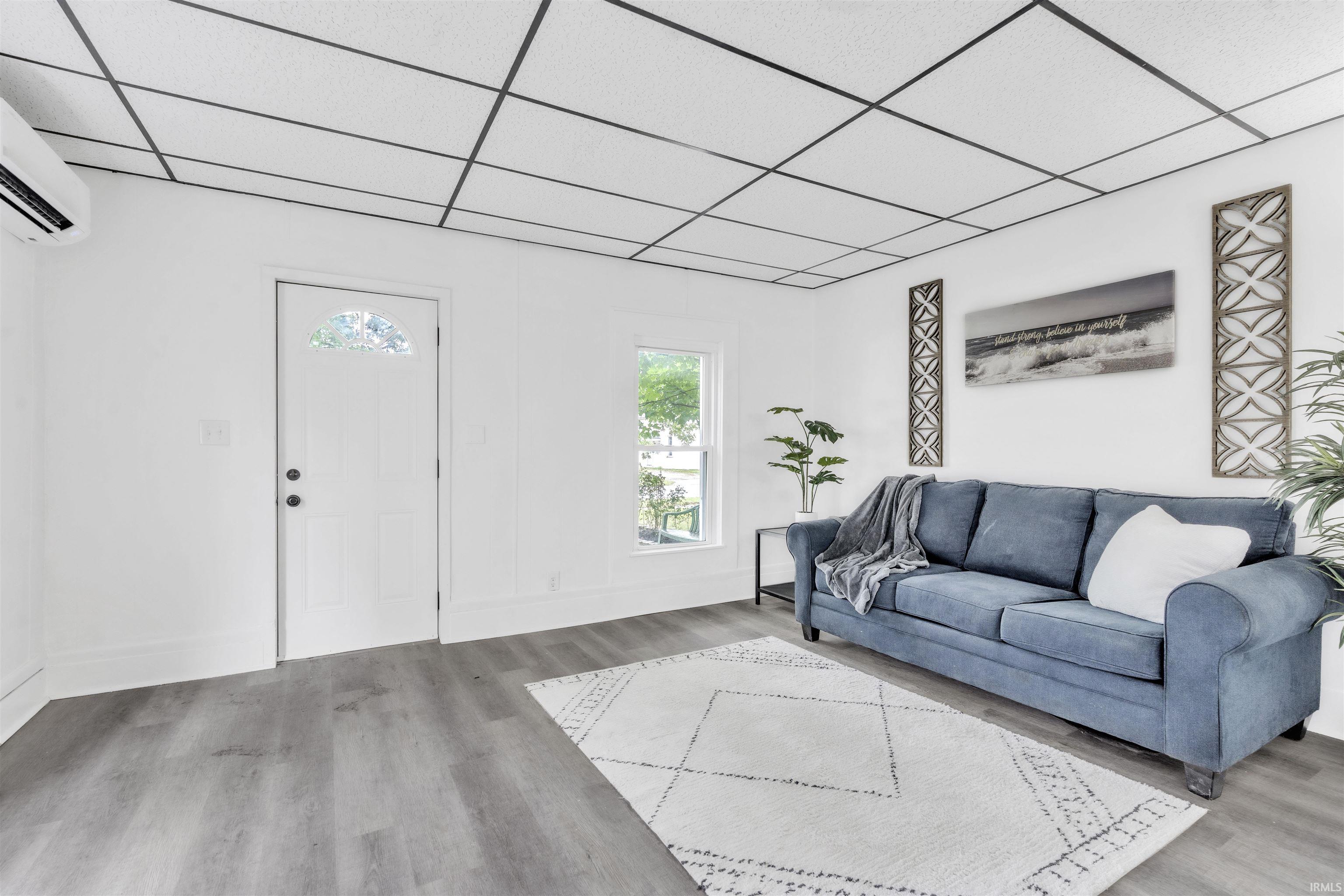 Living area featuring light gray wood-finish flooring and white walls