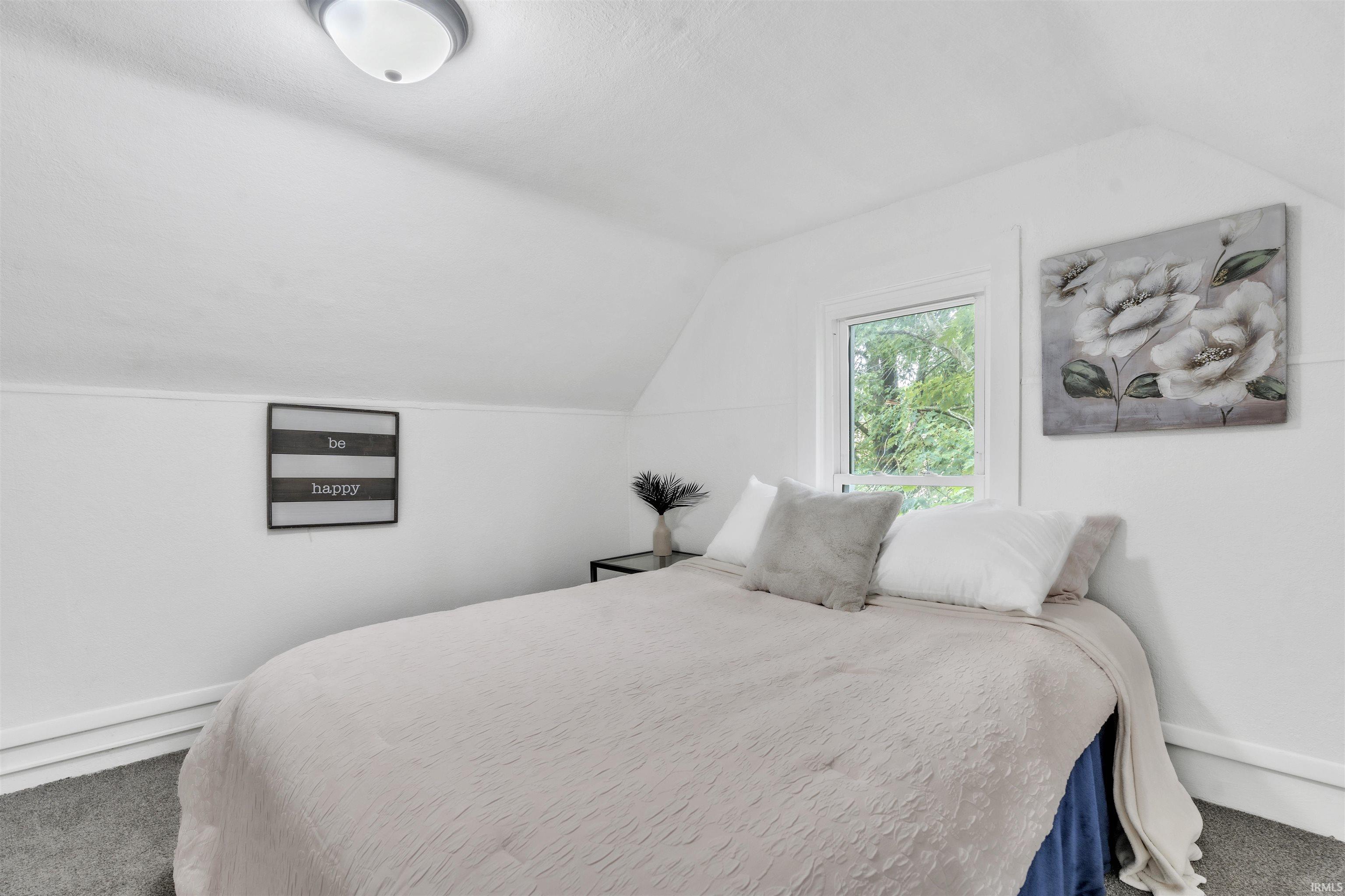 Bright interior space featuring a single window, white walls, and a recessed ceiling light fixture
