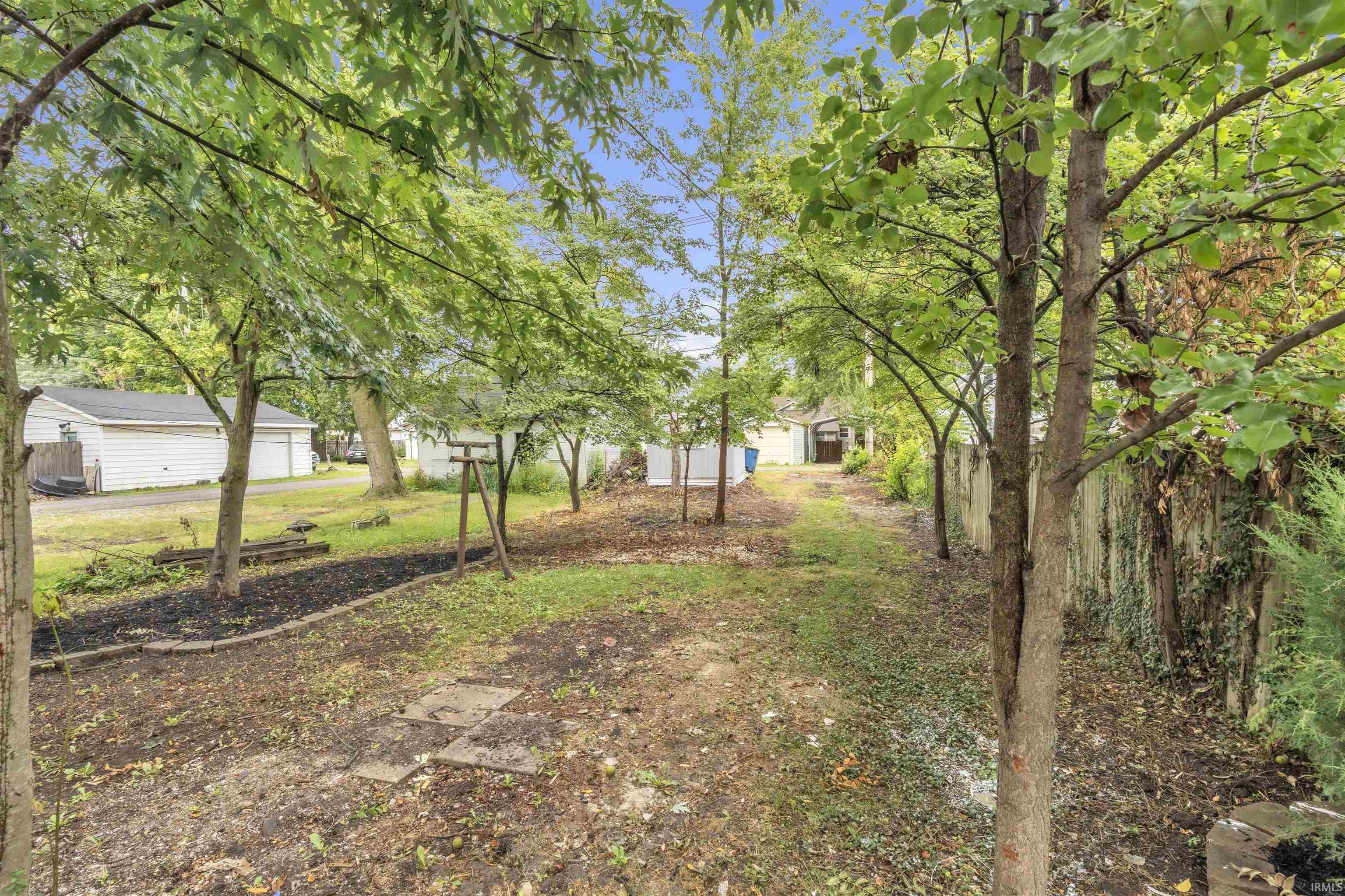 Expansive outdoor area featuring mature trees and a clear path
