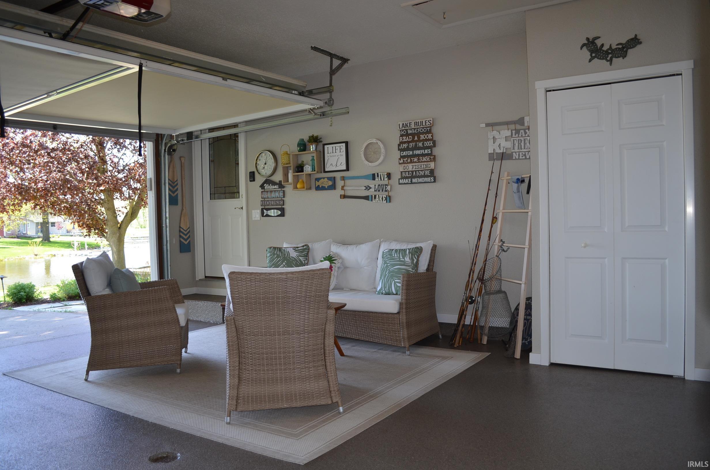 Garage space featuring a bi-fold door, a single door, and a partially open garage door