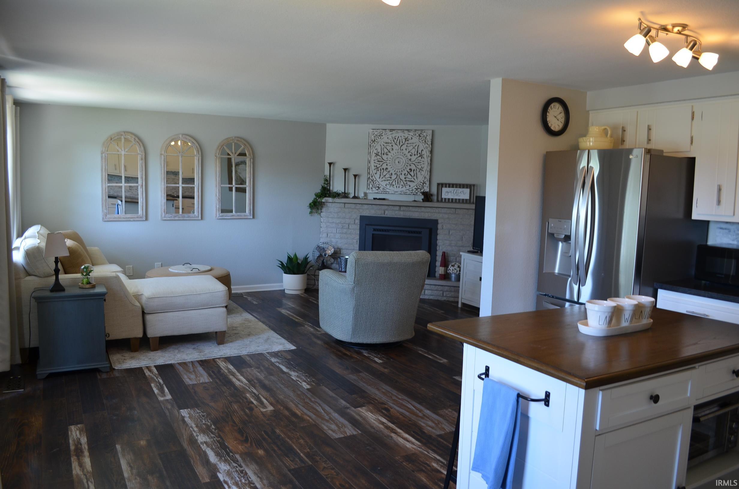 Open-concept living area featuring rich wood-finish flooring
