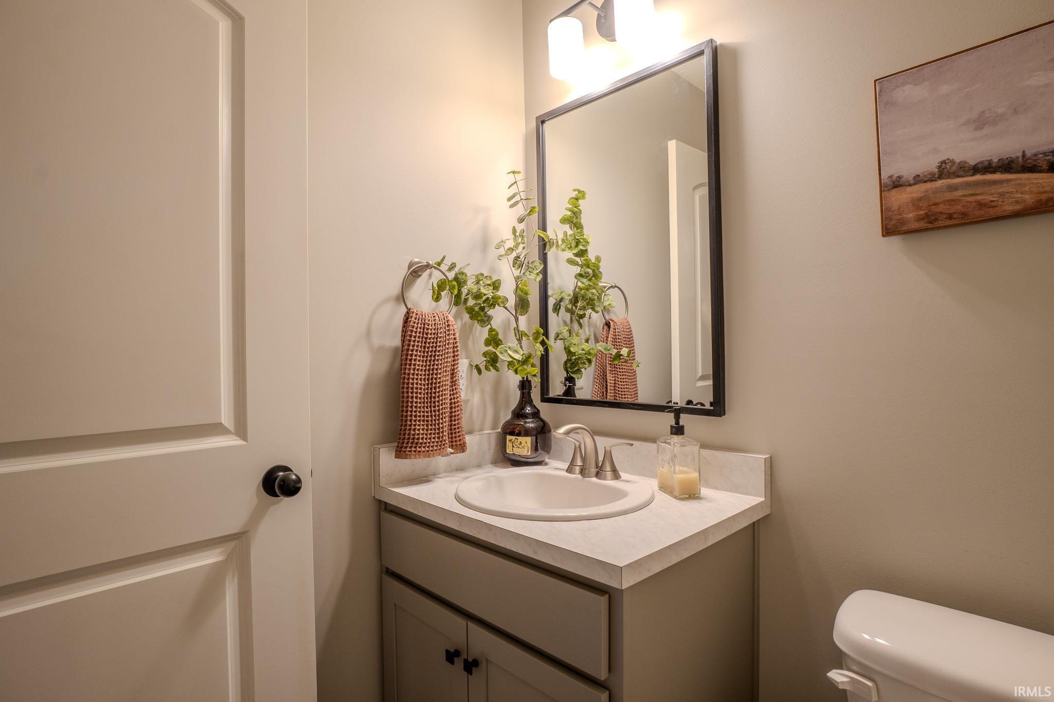 Bathroom vanity featuring a rectangular undermount sink, brushed nickel faucet, and light-toned countertop